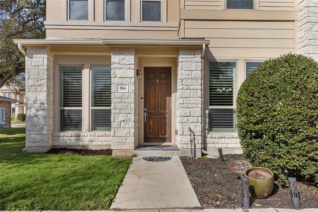 Textured stone pillars frame the welcoming front 