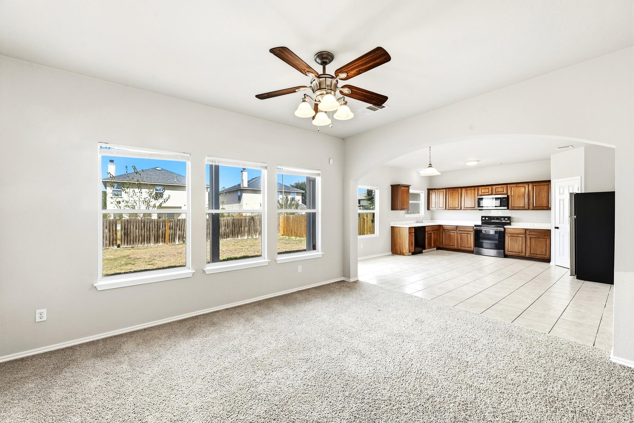 An open floor plan connects the carpeted living a
