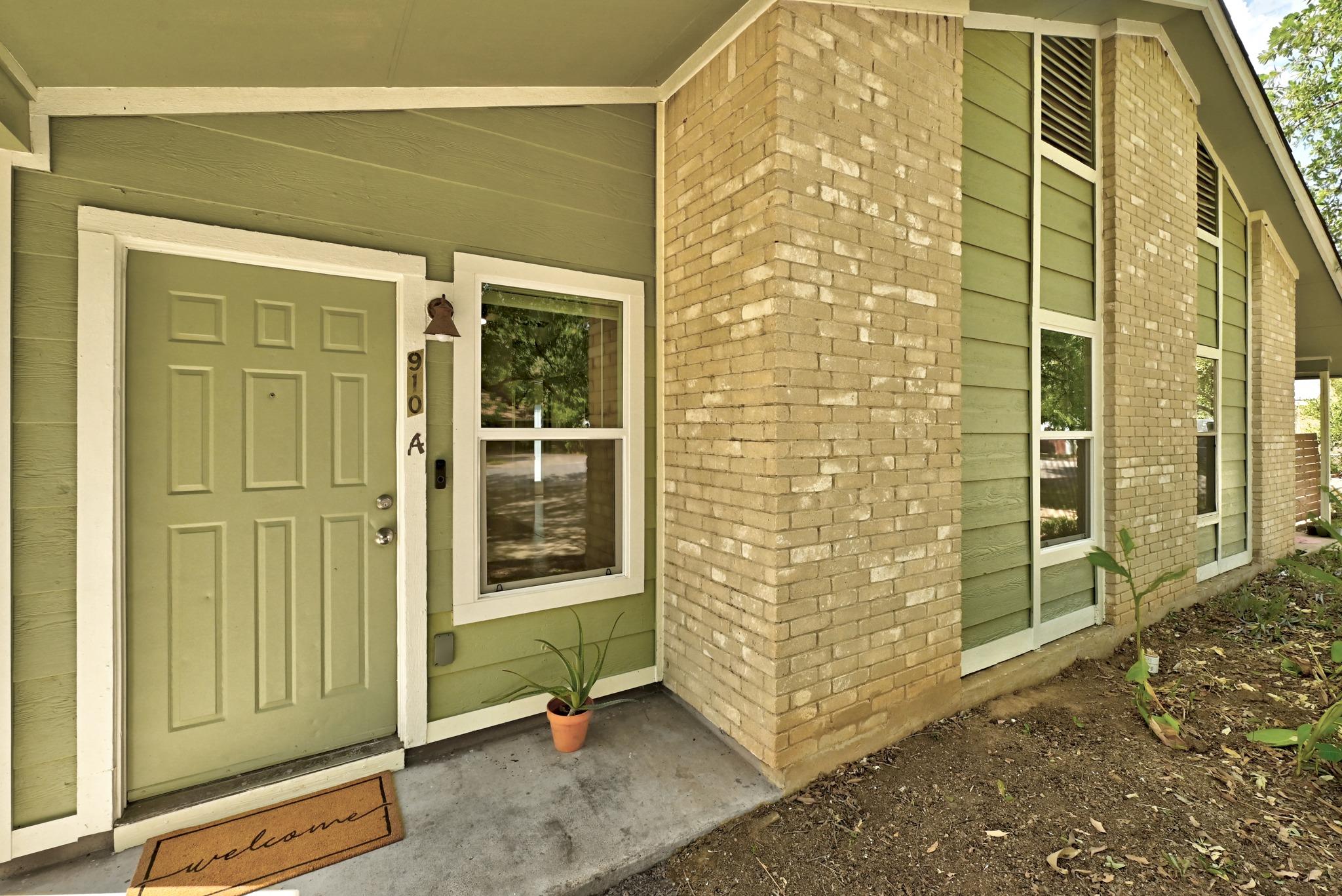 A welcoming front entry features a brick exterior