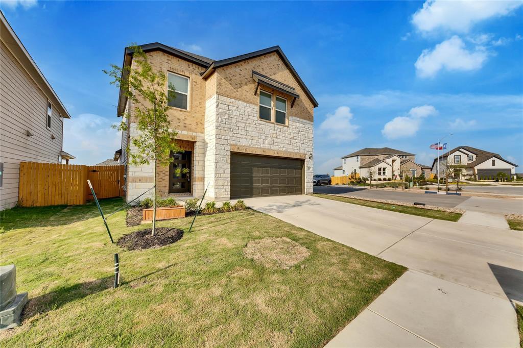 An attractive stone and brick exterior defines th