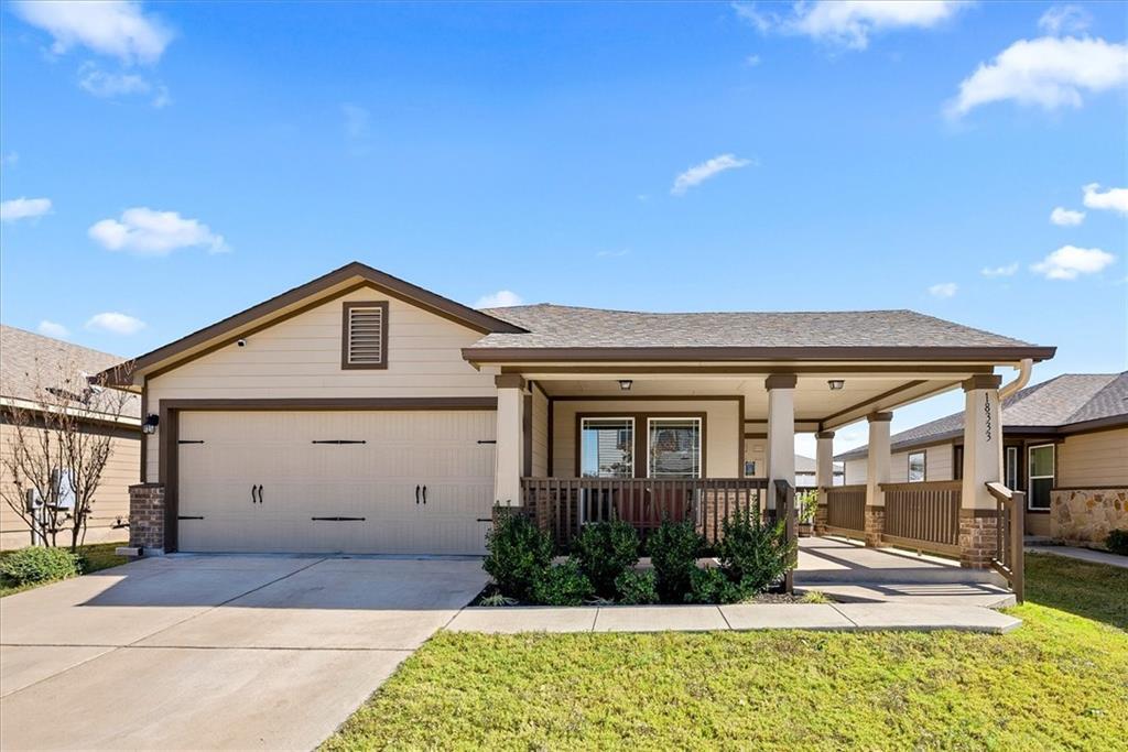 An inviting front porch and spacious driveway cre