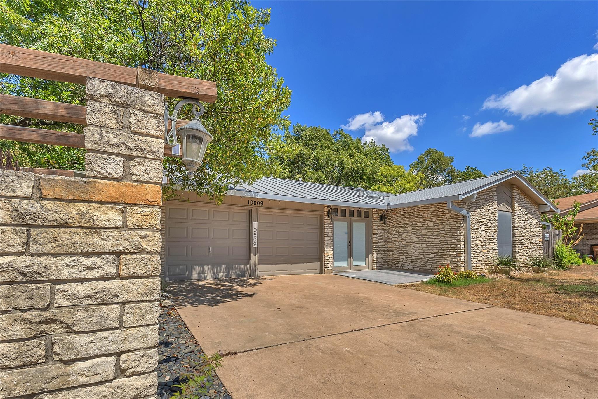 Textured stone facade elements and a modern metal