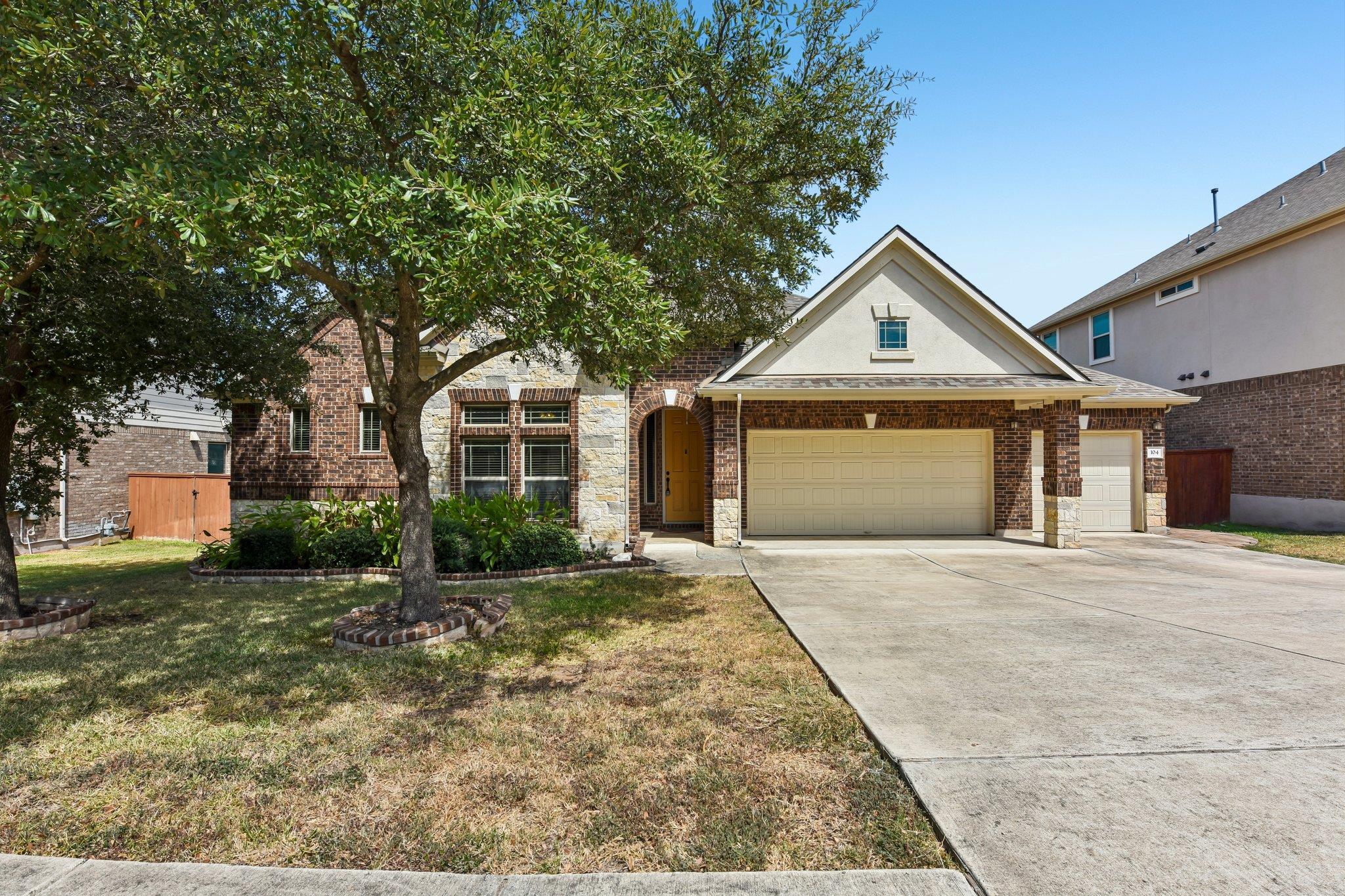 Mature trees shade the front lawn of this classic