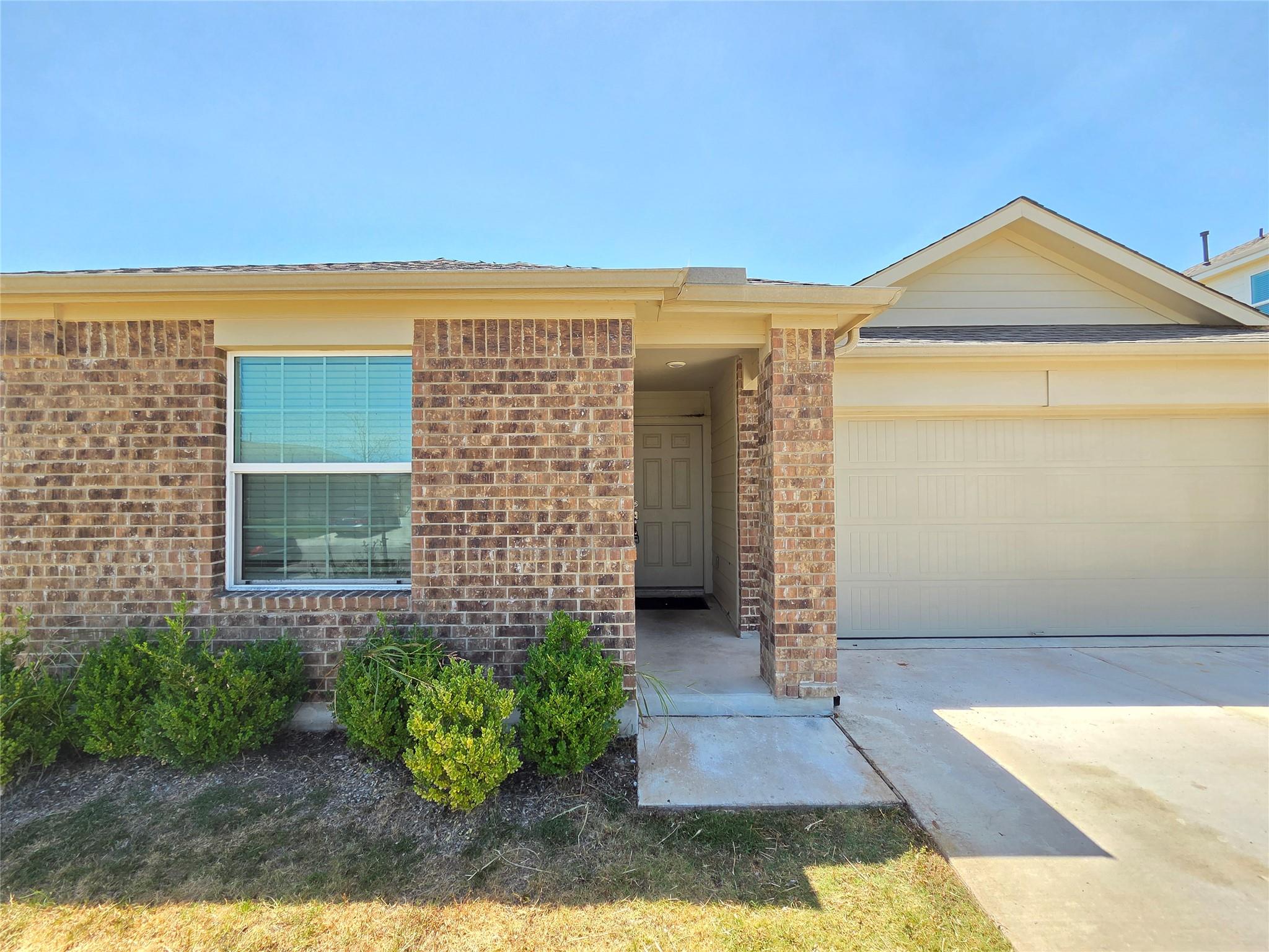 Brick detailing and a recessed entryway create a 