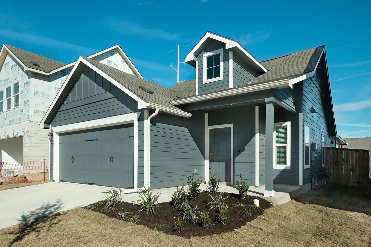 Crisp trim highlights the gables and siding of th