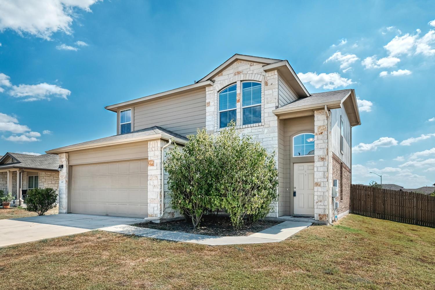 Classic stone and siding accents define the exter