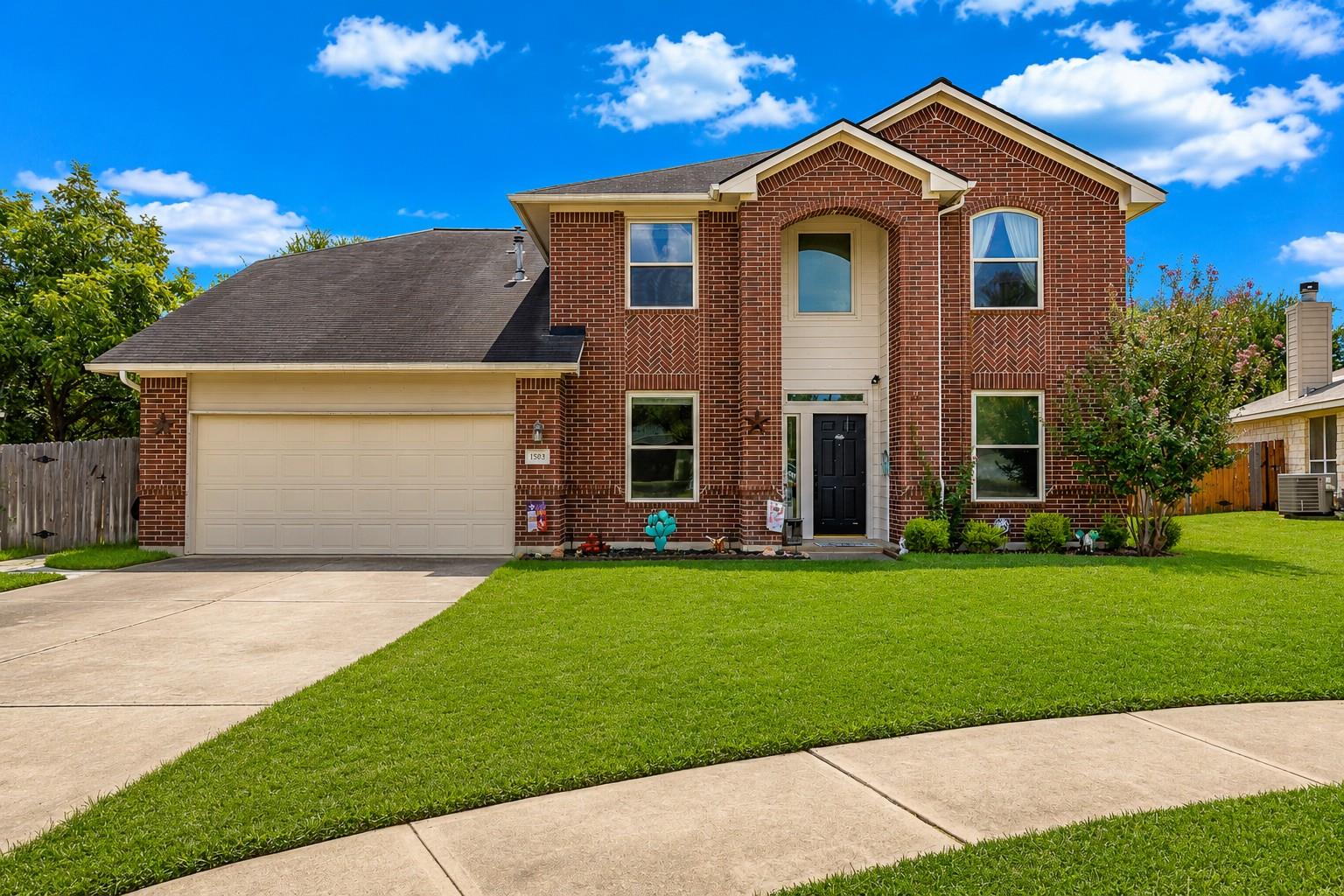 Classic brick exterior showcases a grand arched e