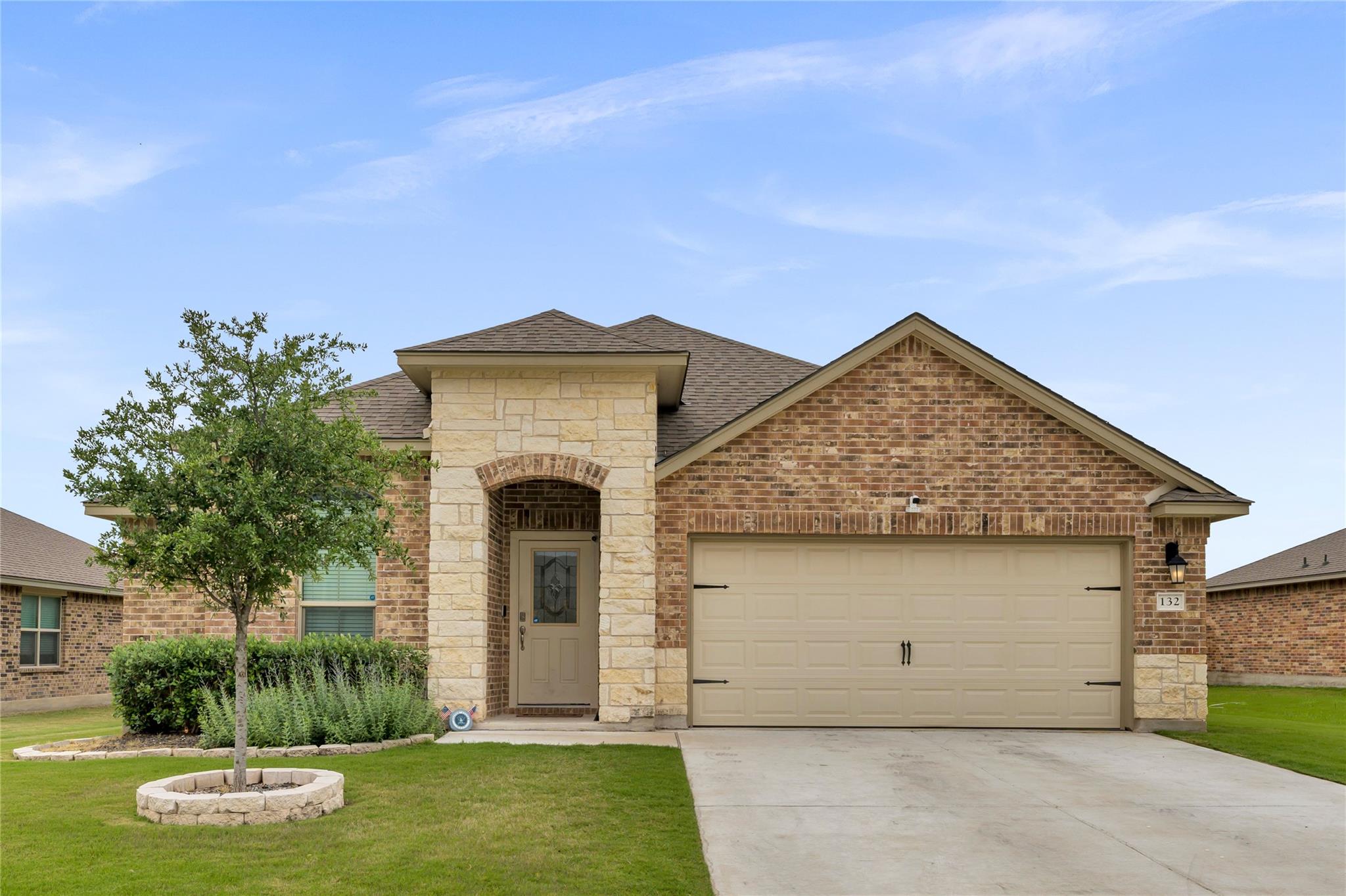 Brick and stone accents define this modern single