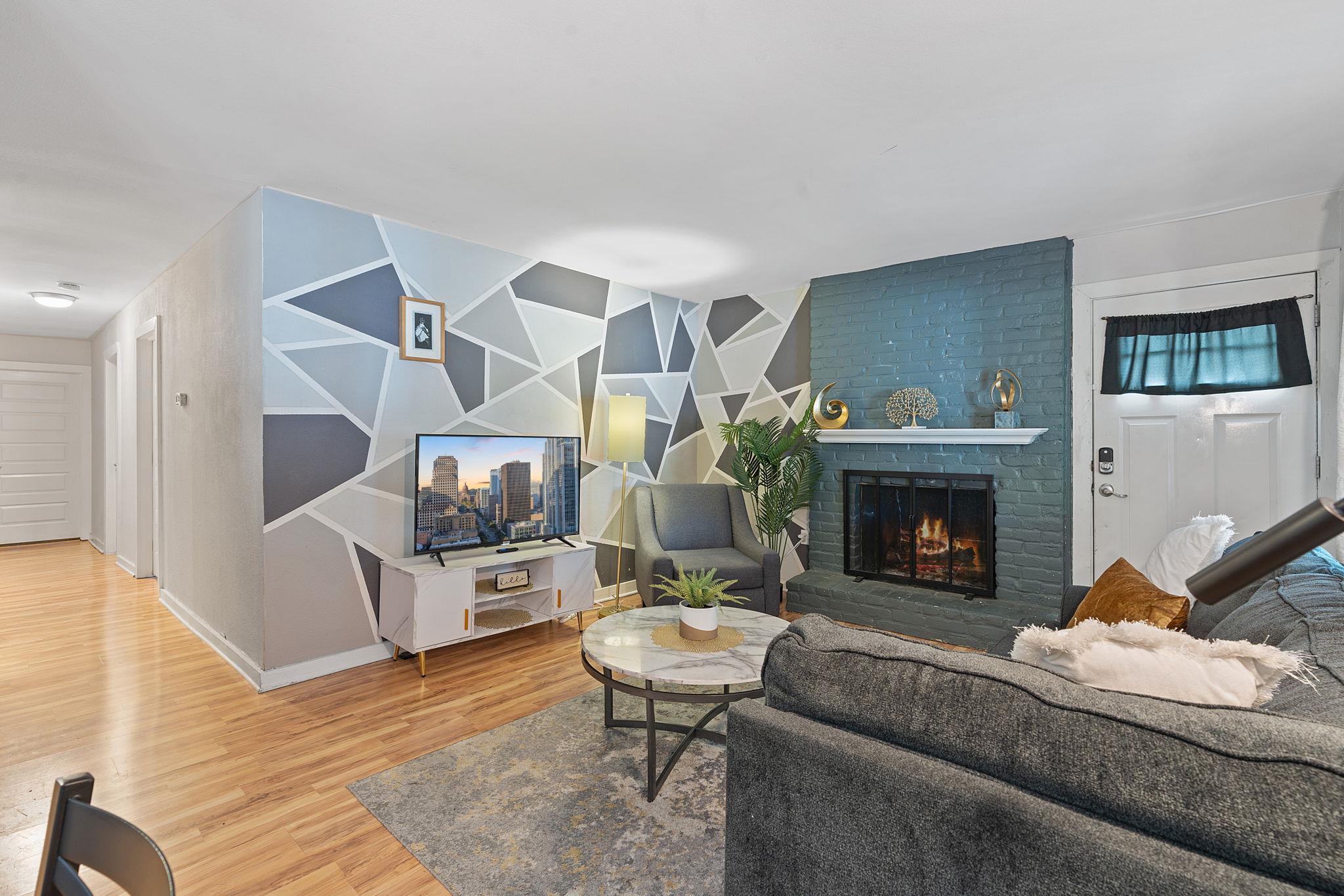 Rich hardwood flooring anchors the living space h