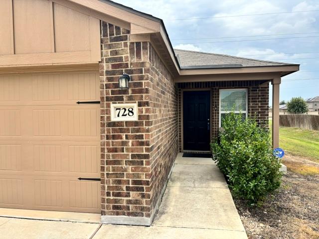 Classic brick accents and a covered entryway welc