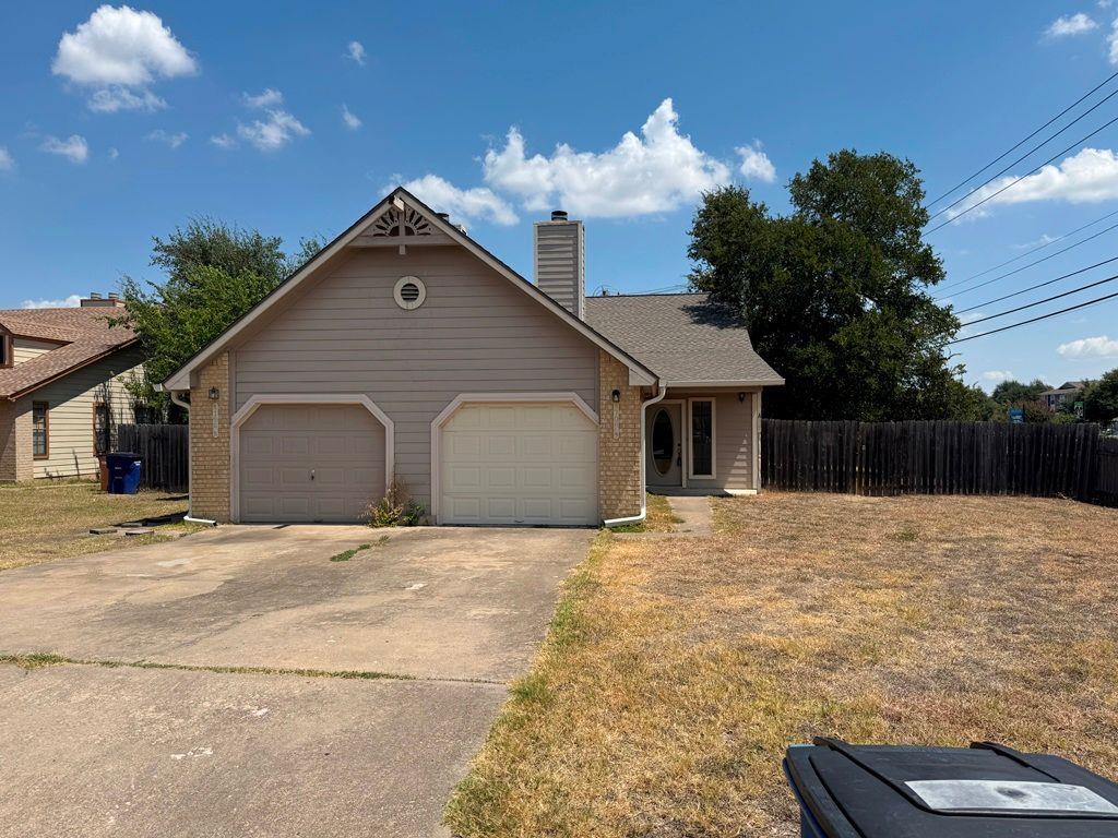 An attached two-car garage sits beside a concrete