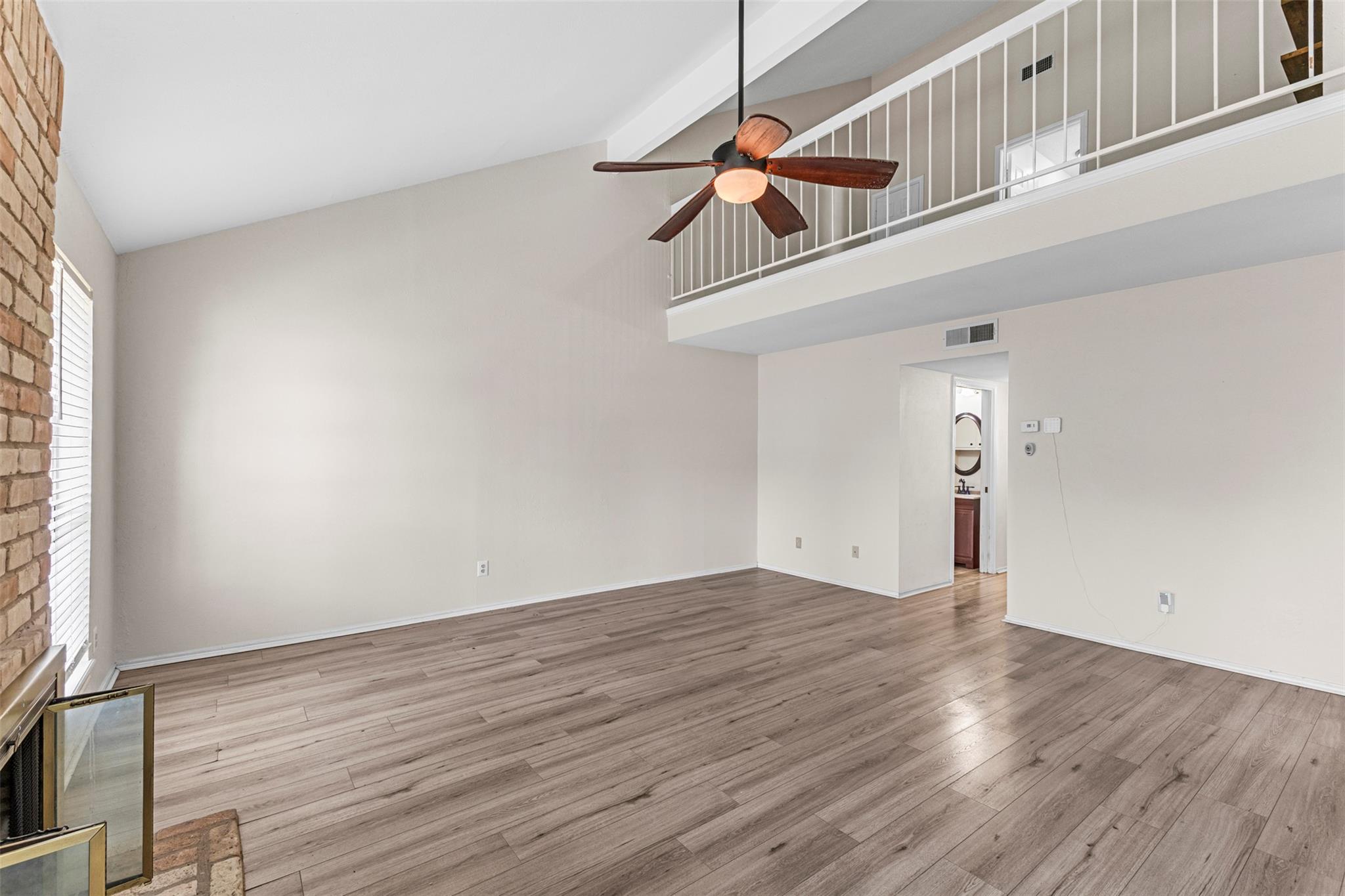 Vaulted ceilings and handsome wood flooring defin