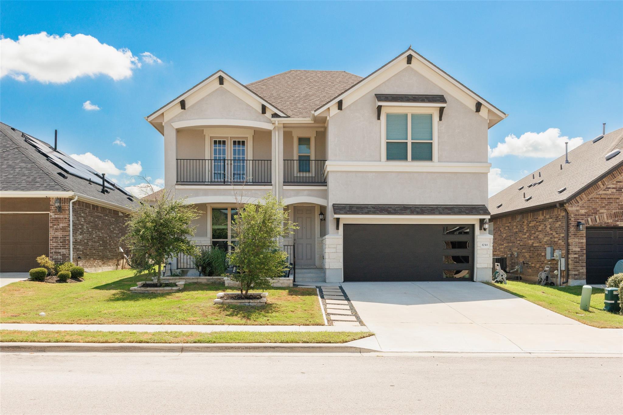 Elegant two-story elevation features a modern gar