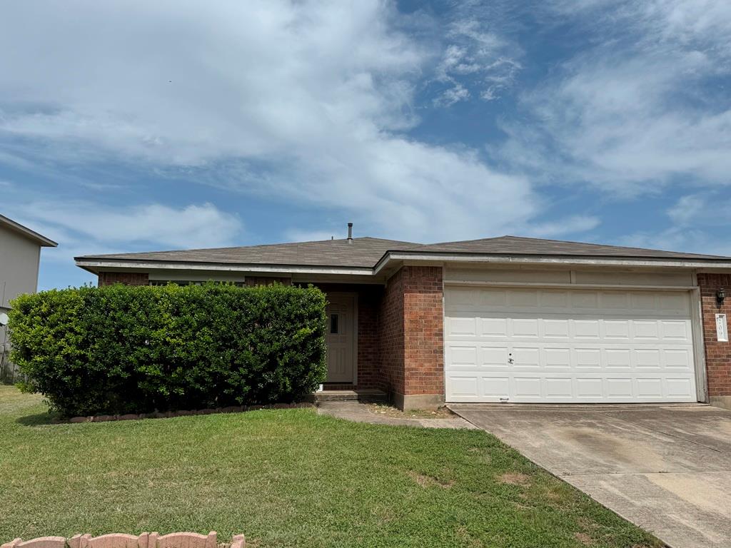 Ranch-style home featuring brick siding, concrete