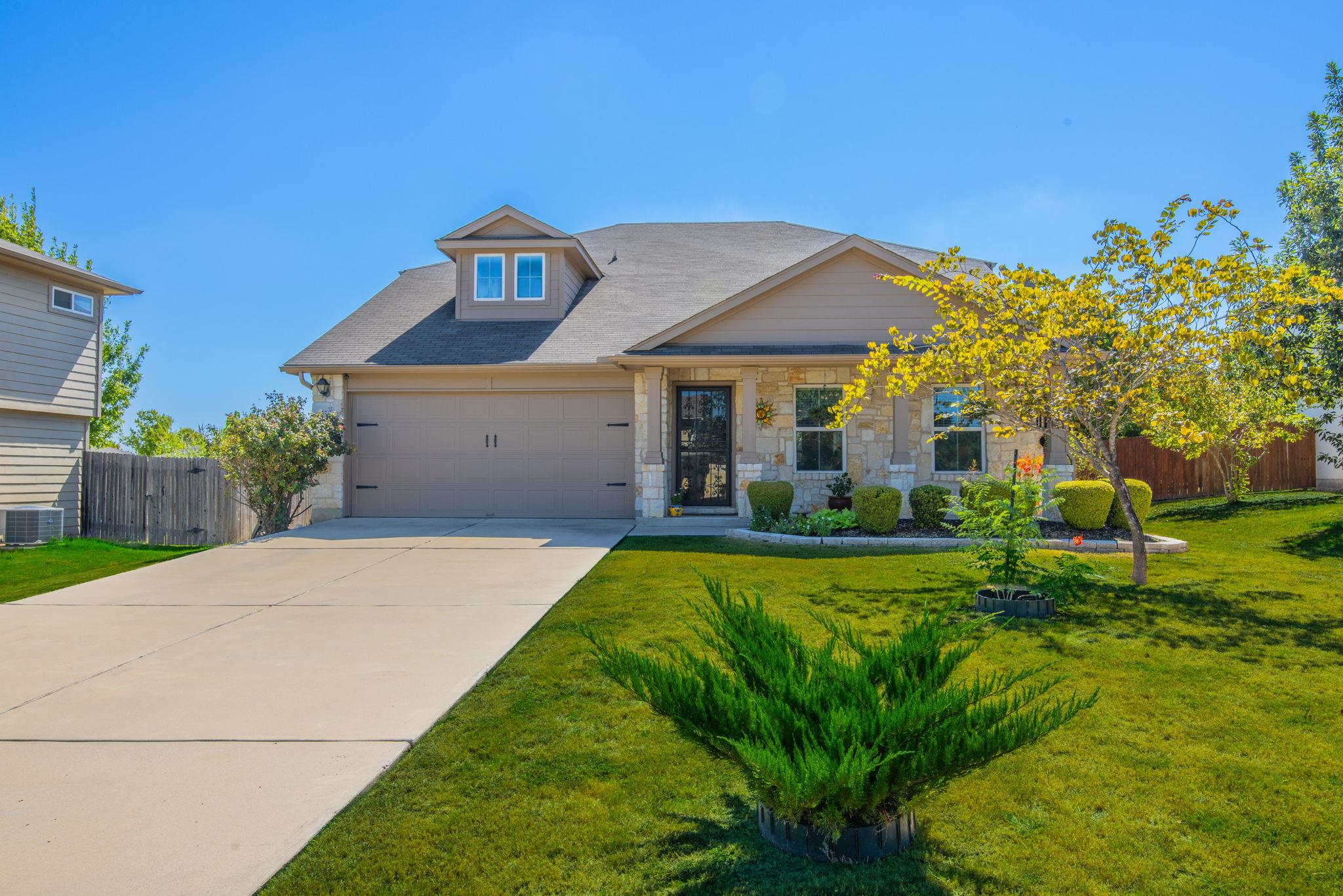 Stone and siding accents complement the gabled ro