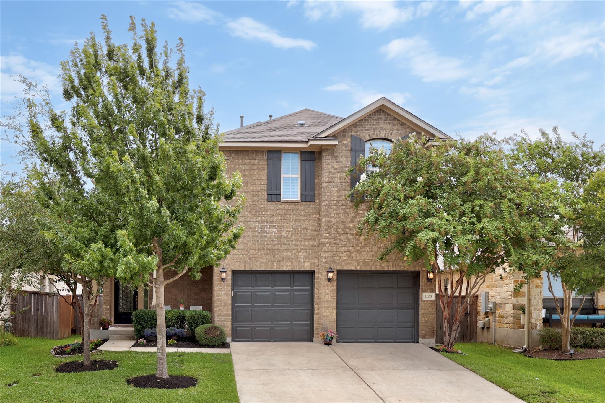 Stately brick exterior featuring a two-car garage