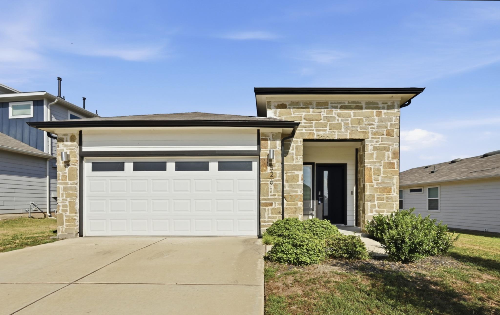 Natural stone accents and a modern facade create 