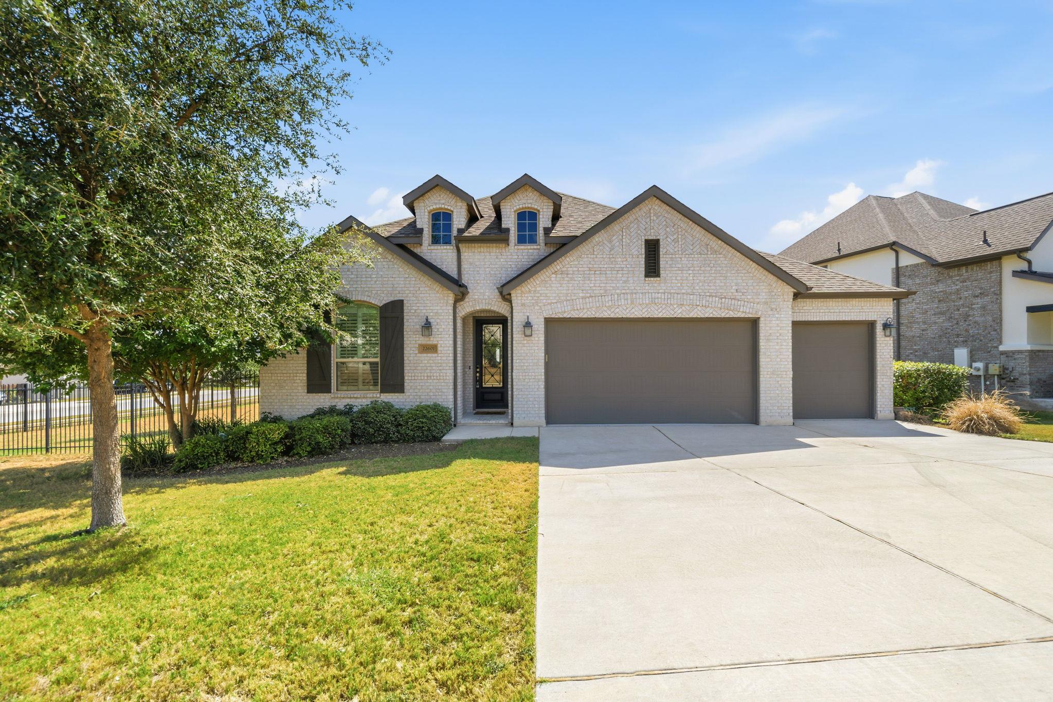A classic brick exterior and concrete driveway de