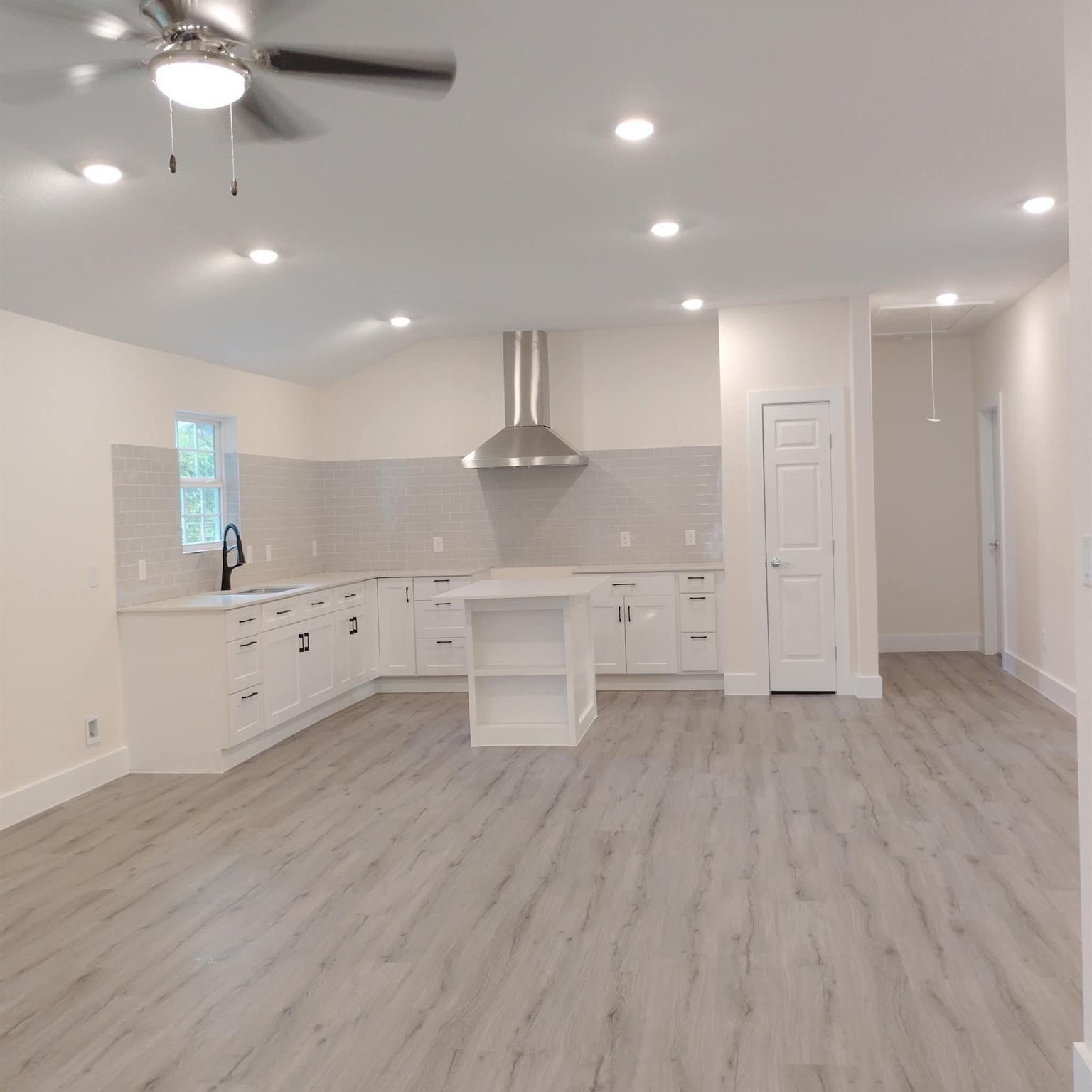 Crisp white cabinetry paired with modern flooring