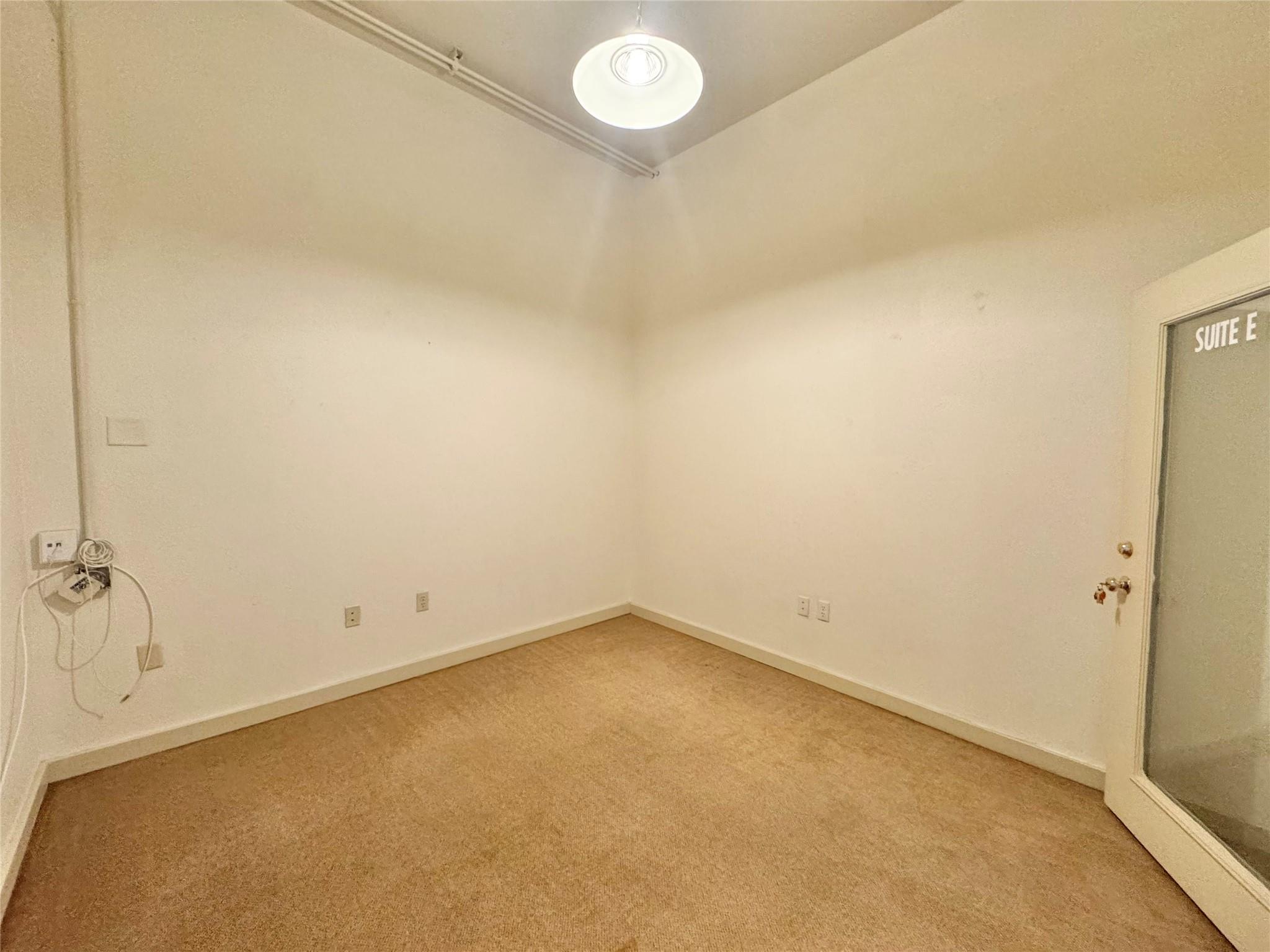 High ceilings and soft neutral carpeting define t