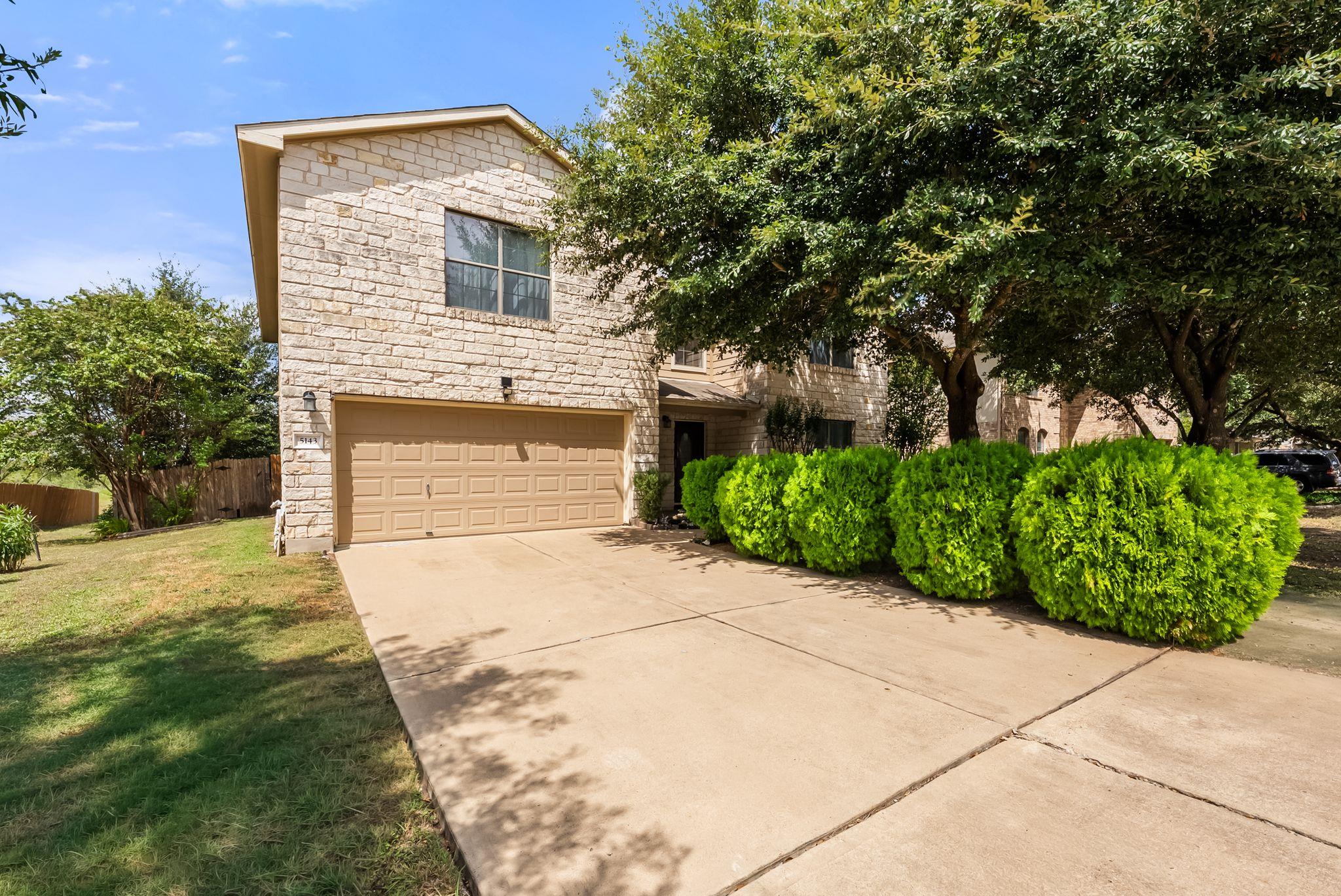 Mature shade trees and structured stone masonry f