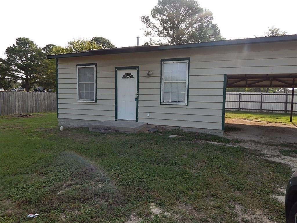 Horizontal siding and an attached carport define 