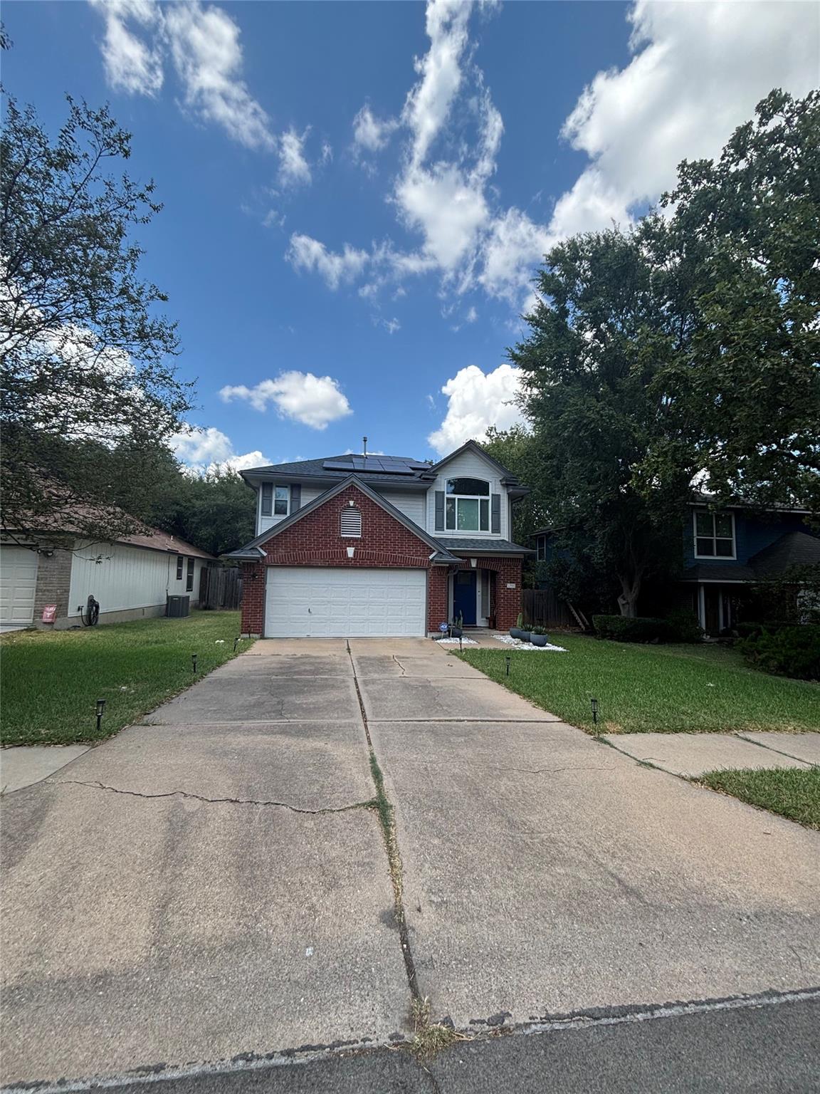A long concrete driveway leads directly to an att