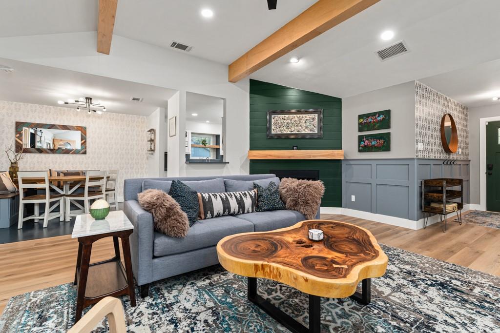 Beamed ceilings and a cozy fireplace create a war