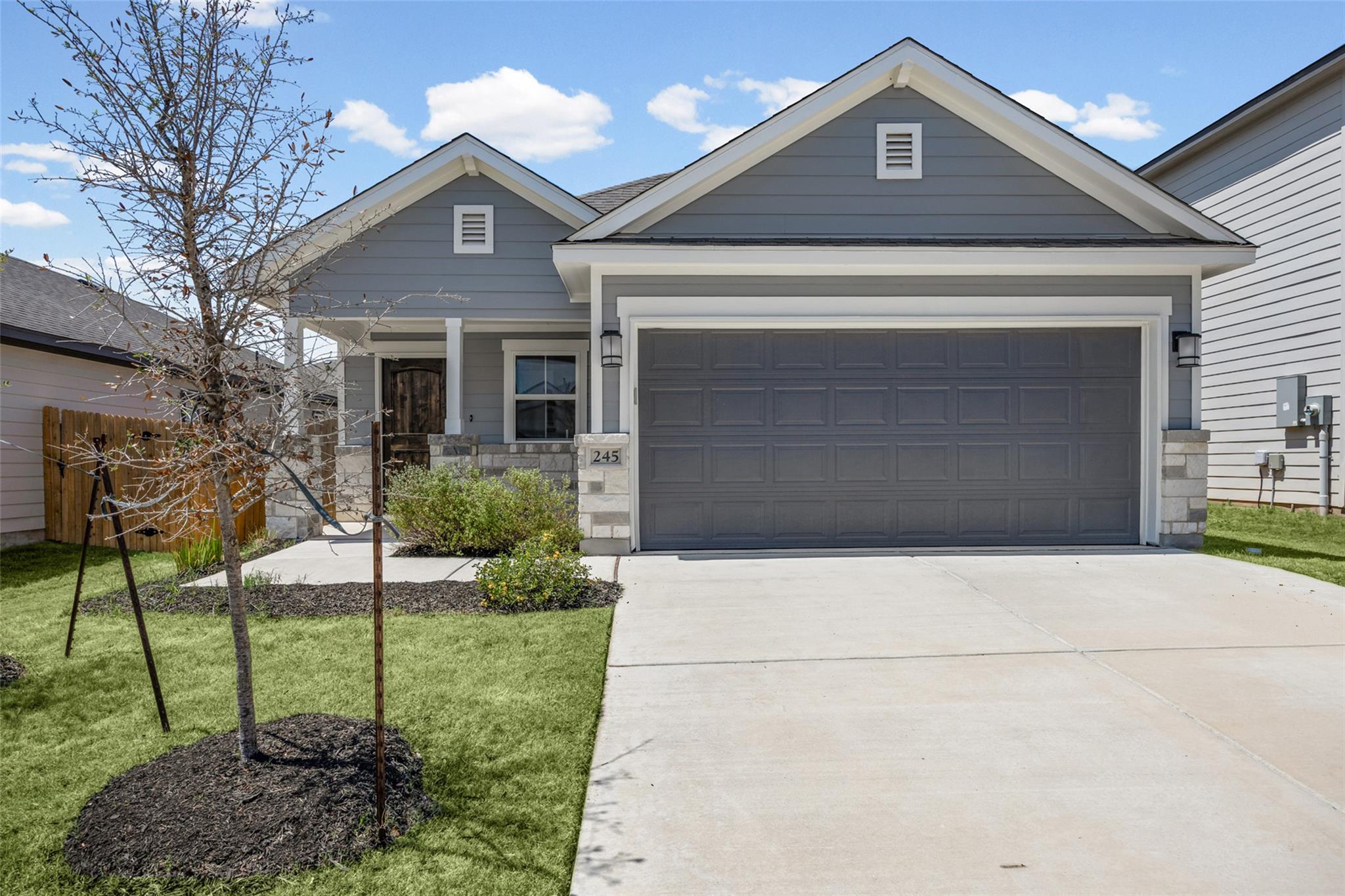 A concrete driveway leads to a modern home exteri