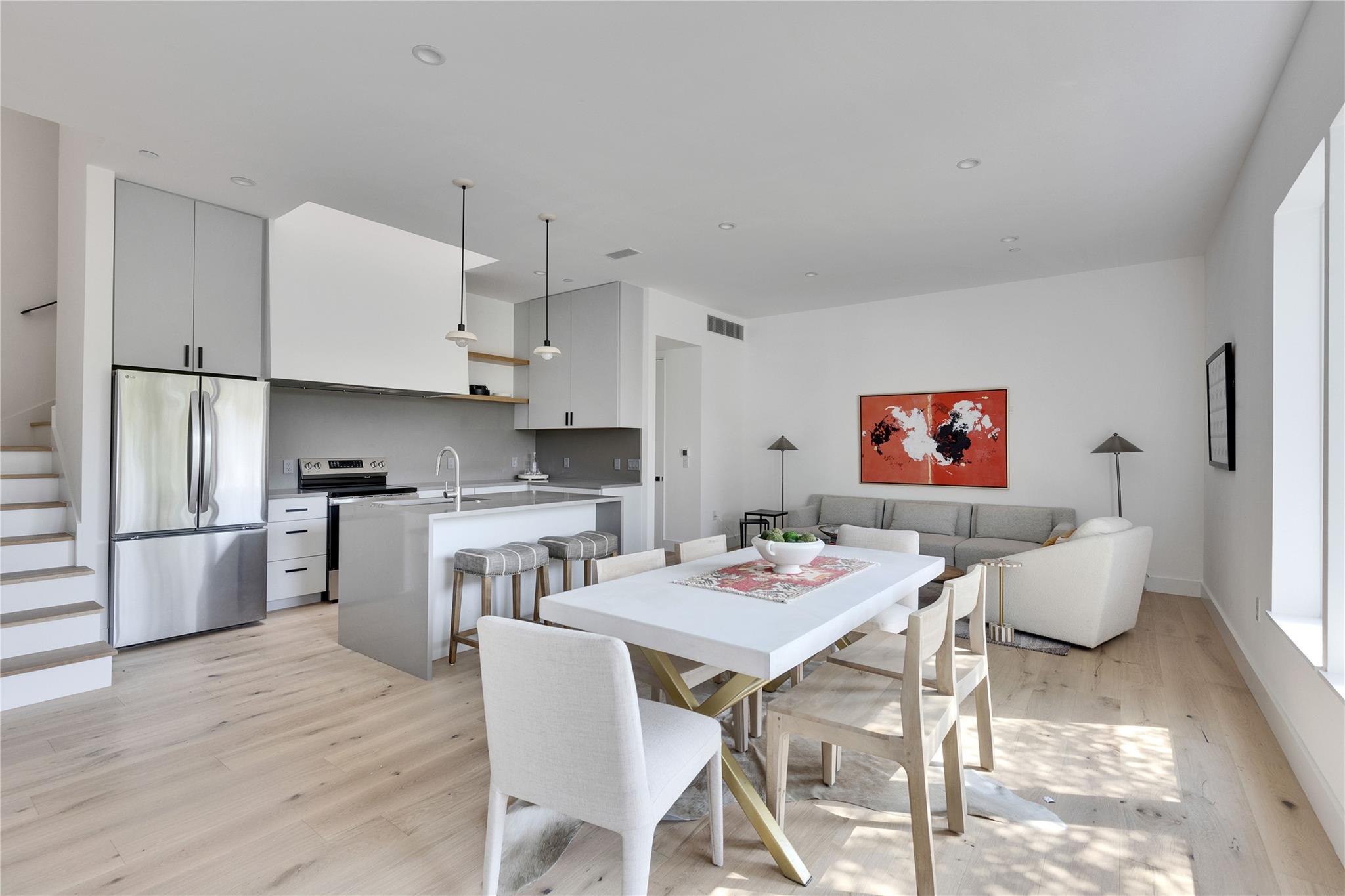 Sunlight streams across the light wood flooring o