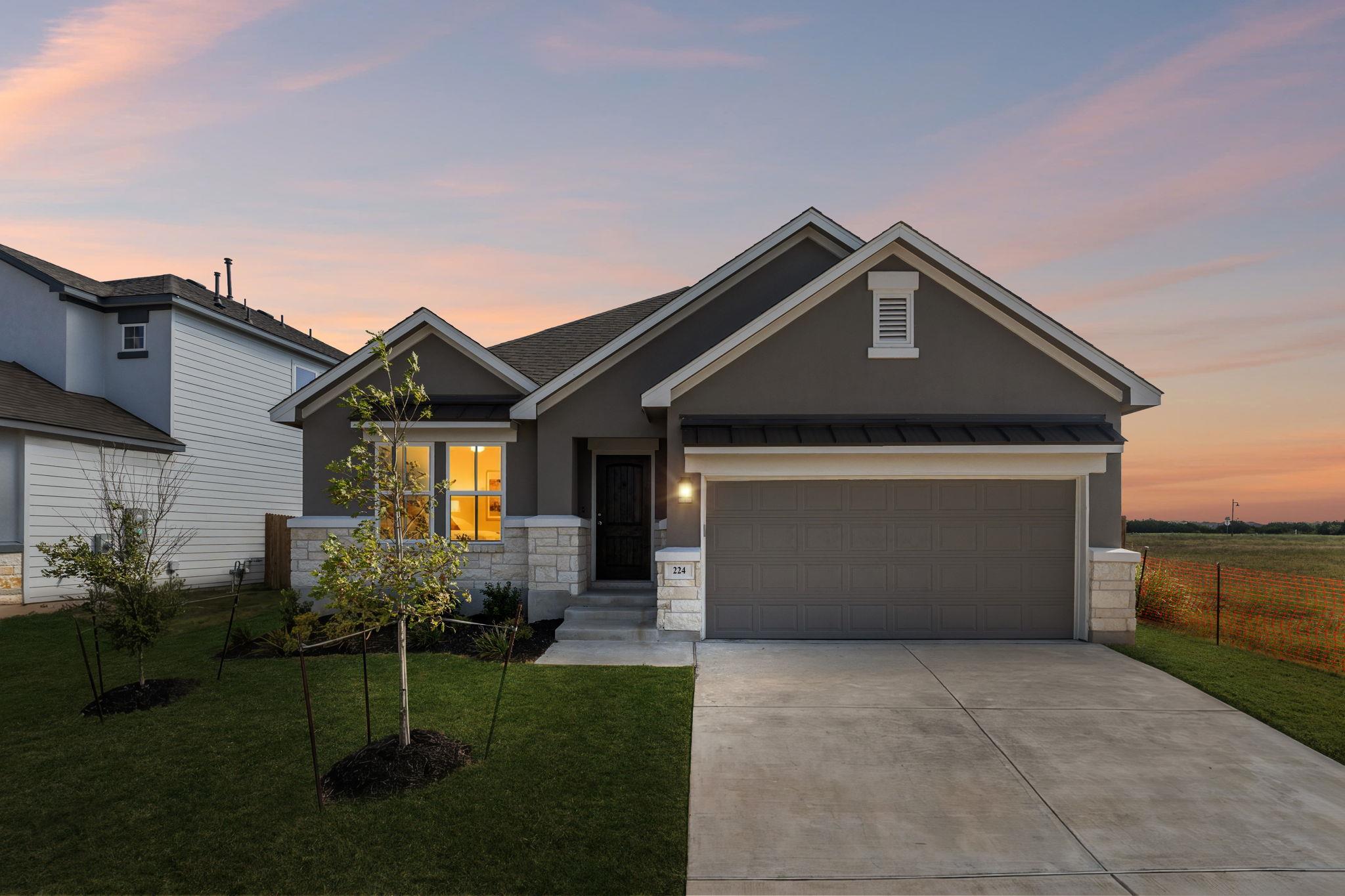A classic concrete driveway leads to this modern 