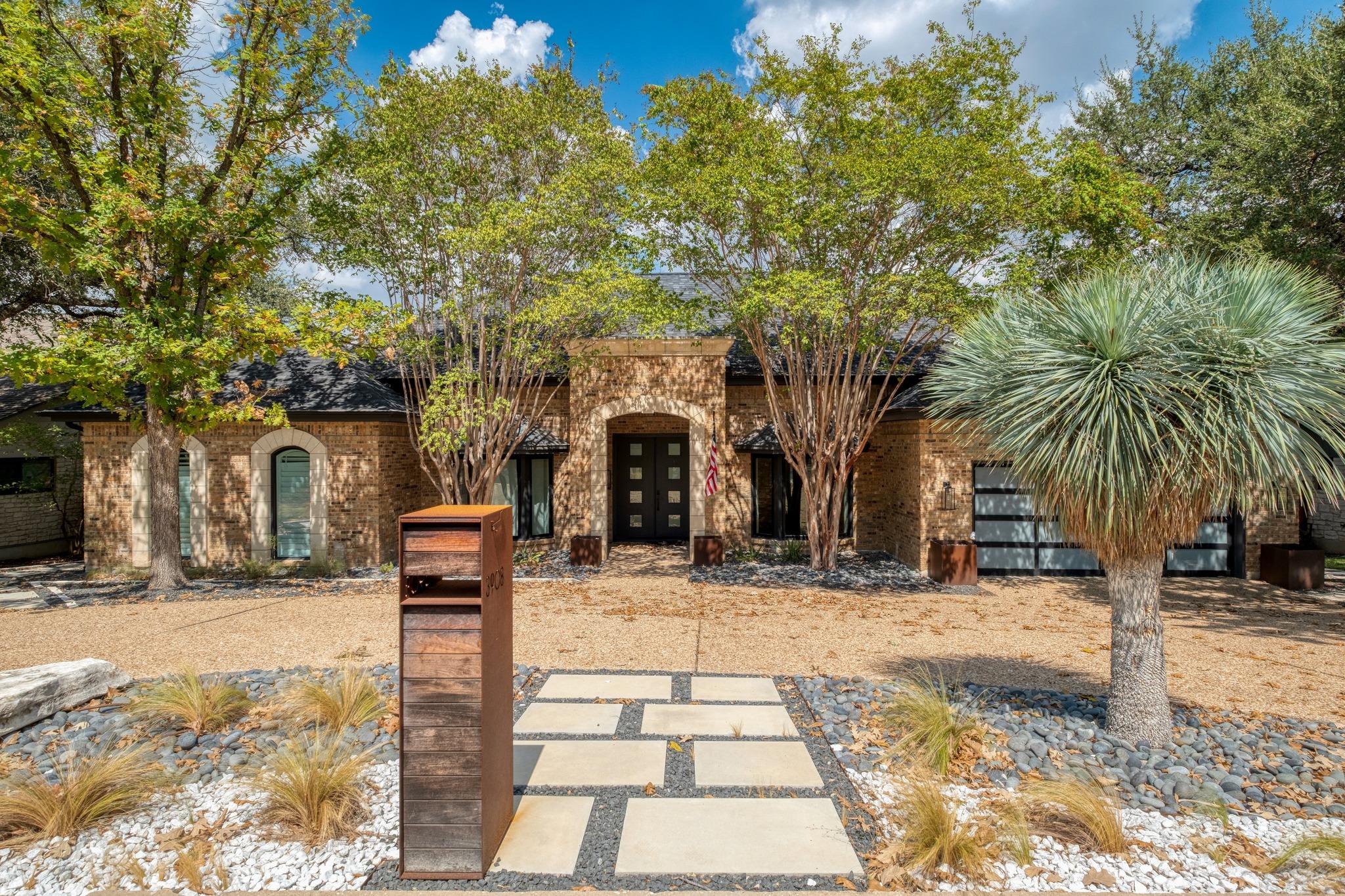 Lush landscaping frames the classic brick exterio