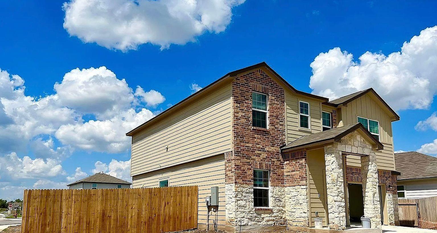 Two-story residence featuring a combination exter