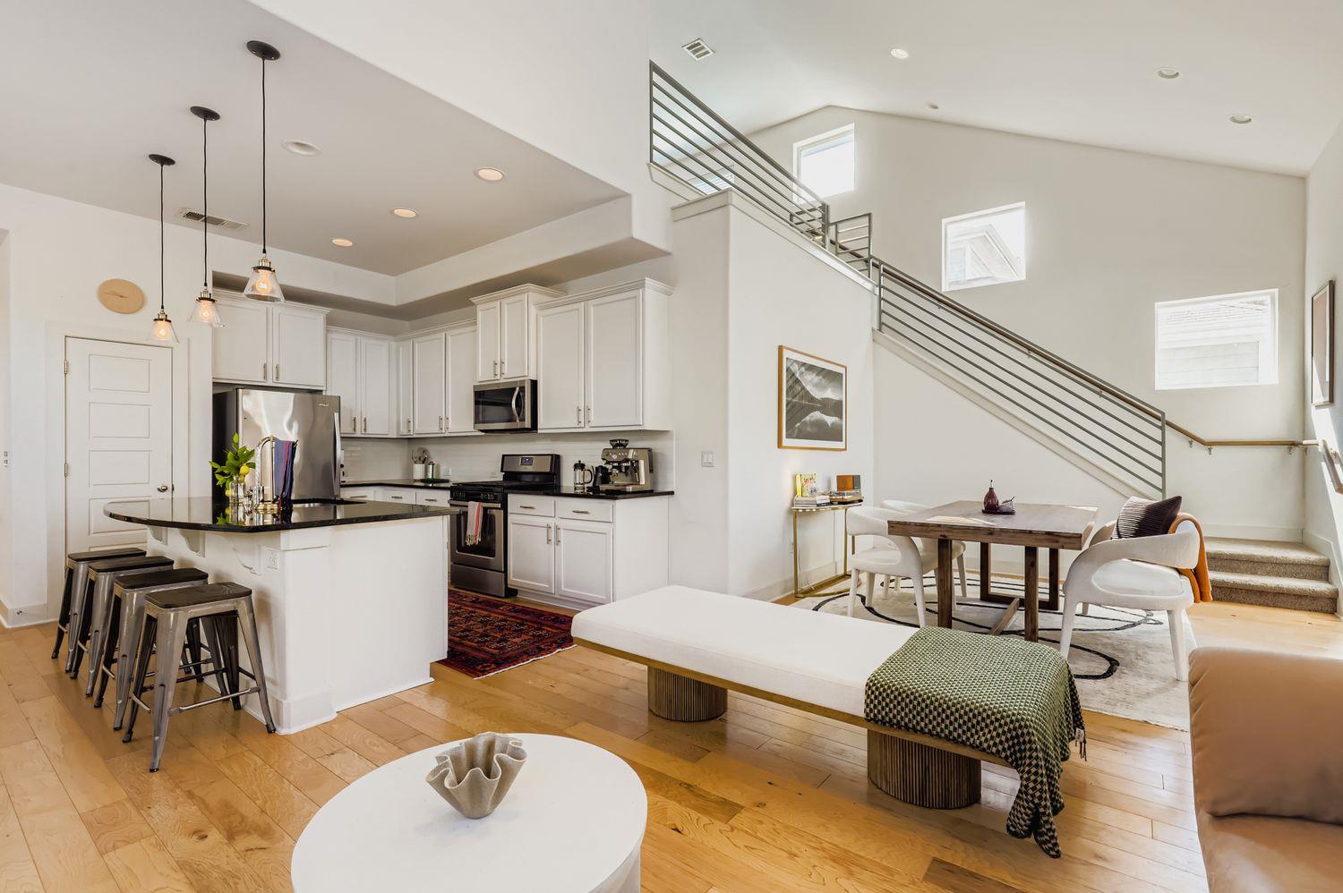 Gleaming hardwood floors and a modern metal stair