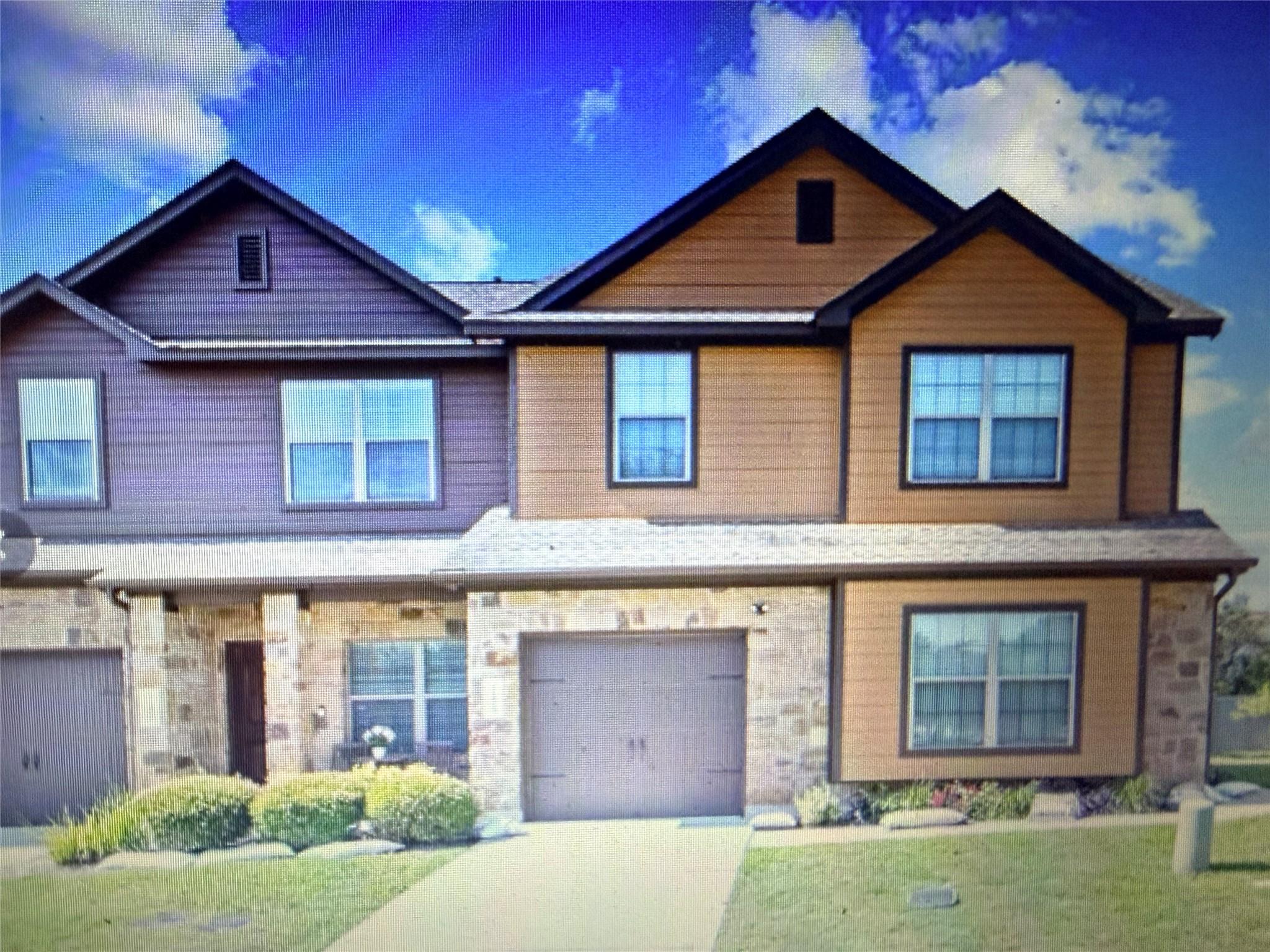Gabled rooflines and stone accents define this mu