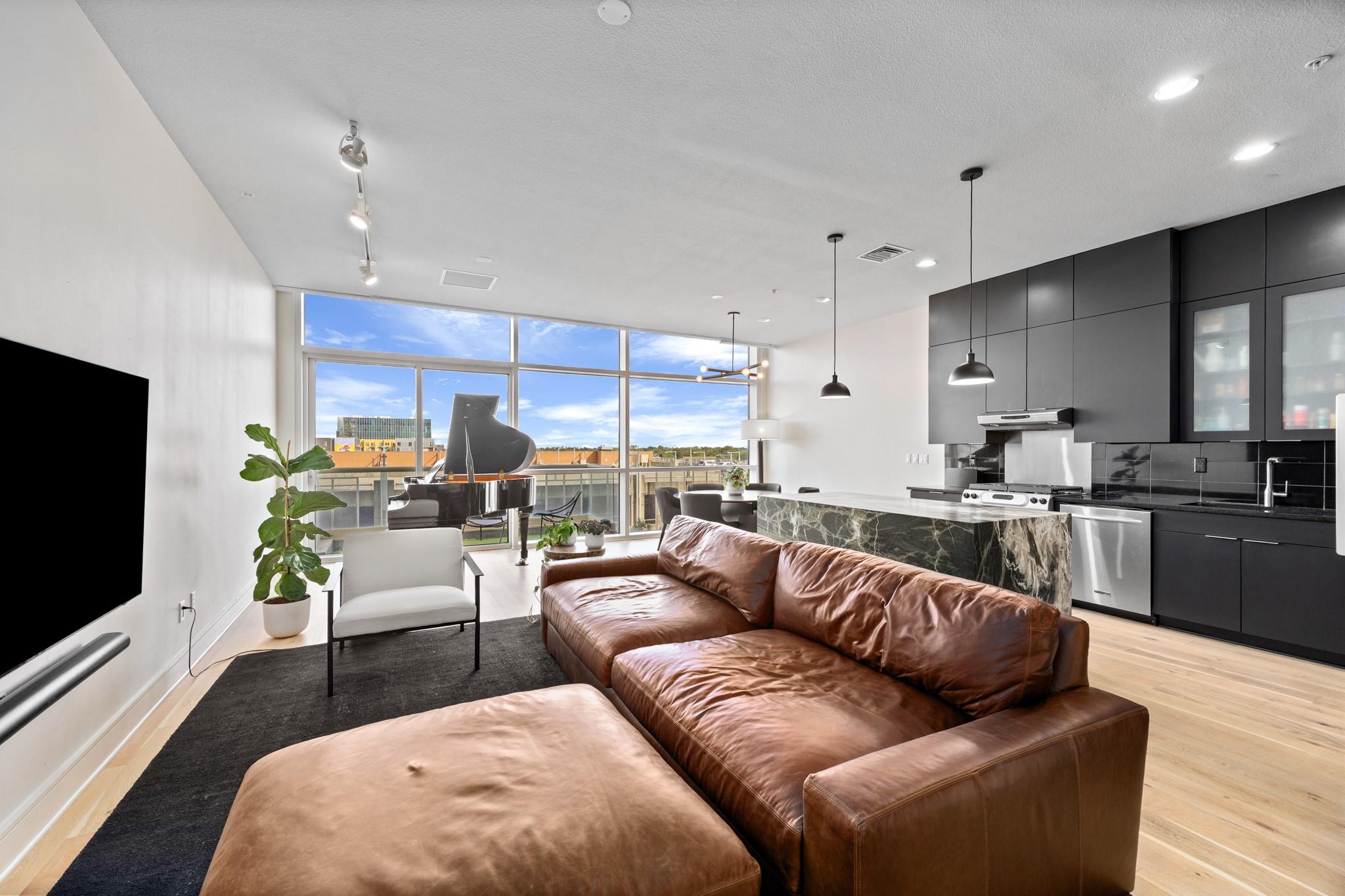 Floor-to-ceiling windows bathe this open-concept 