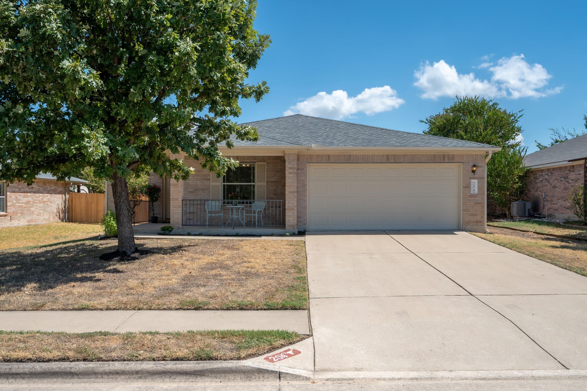 Classic brick exterior showcases a two-car garage