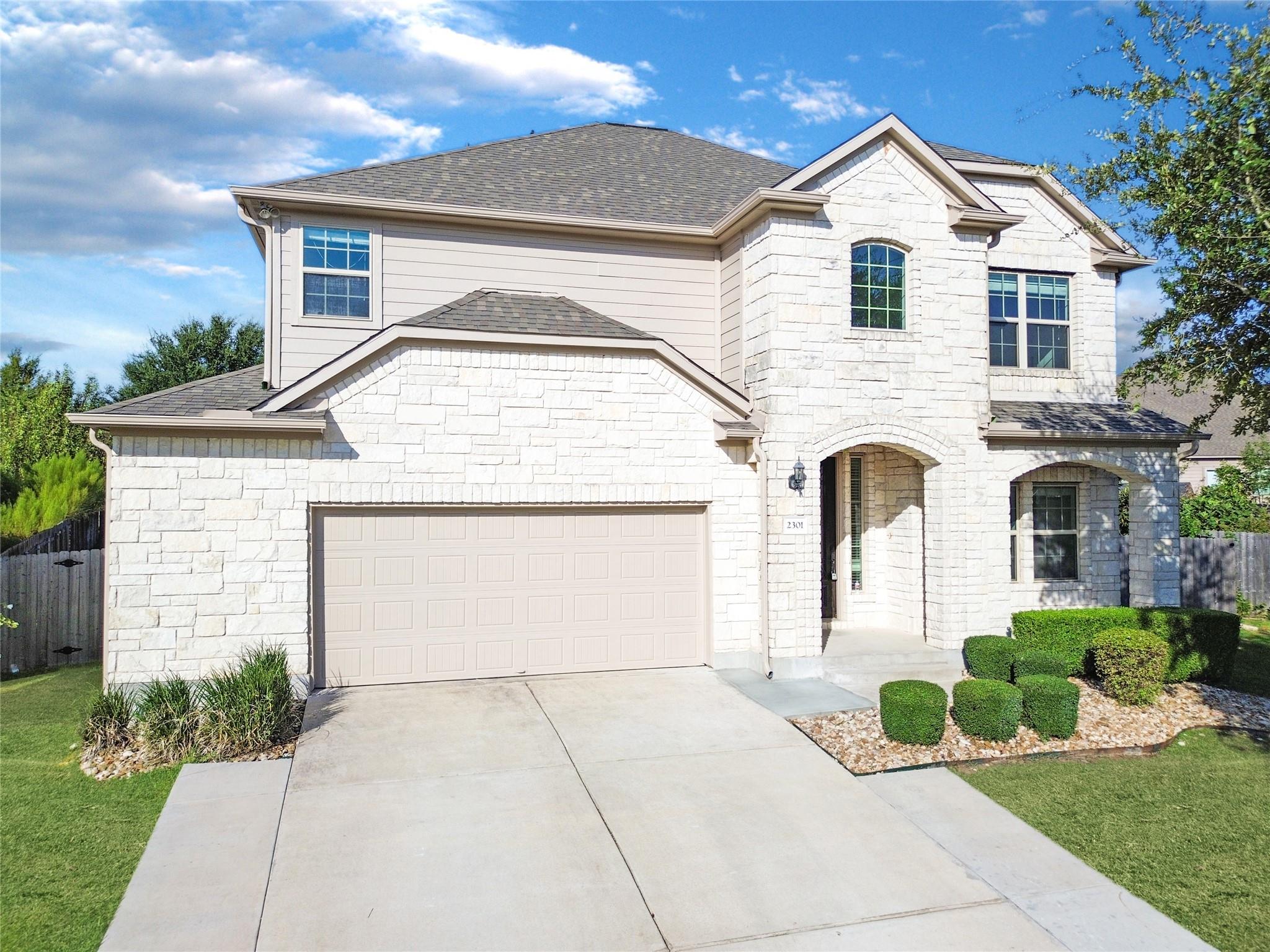 Textured light stone masonry and a classic shingl
