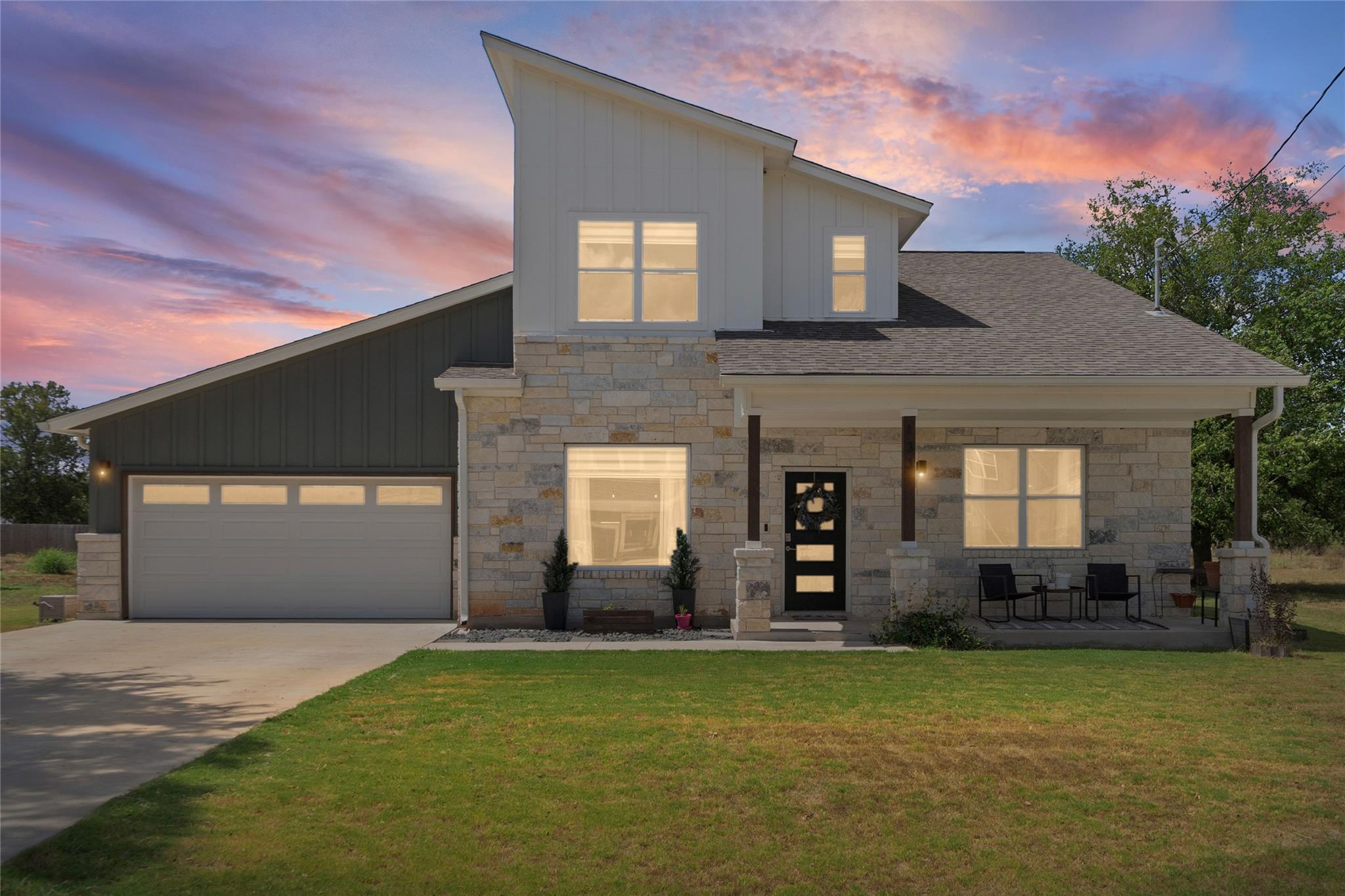 Bold modern rooflines and natural stone siding de