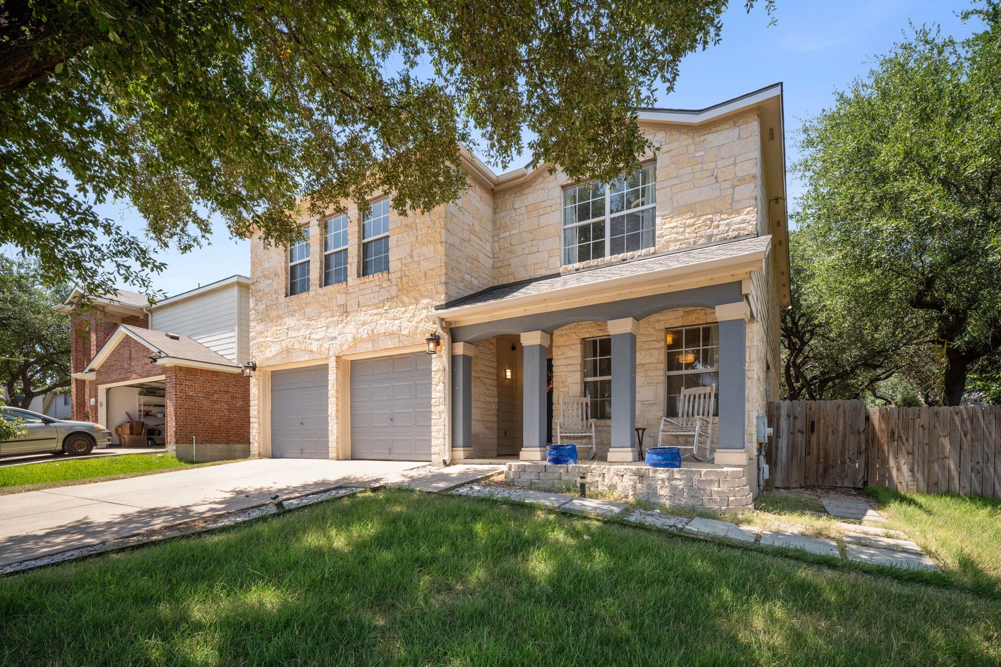 Limestone masonry and a welcoming front porch def