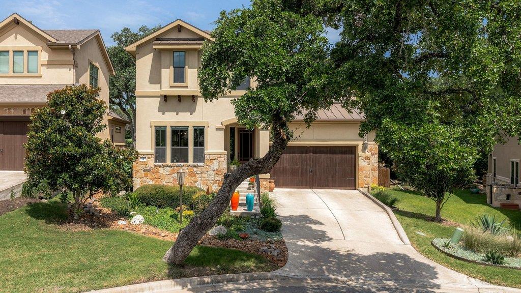 A stone and stucco exterior pairs with a concrete