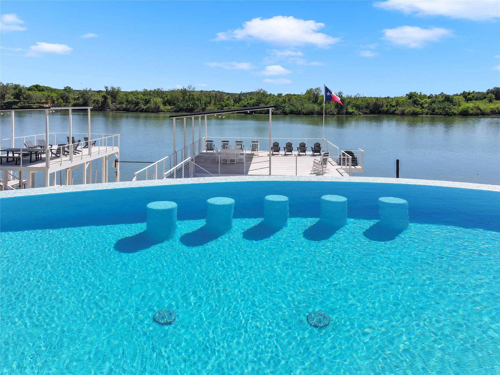 An infinity edge pool overlooks private boat dock