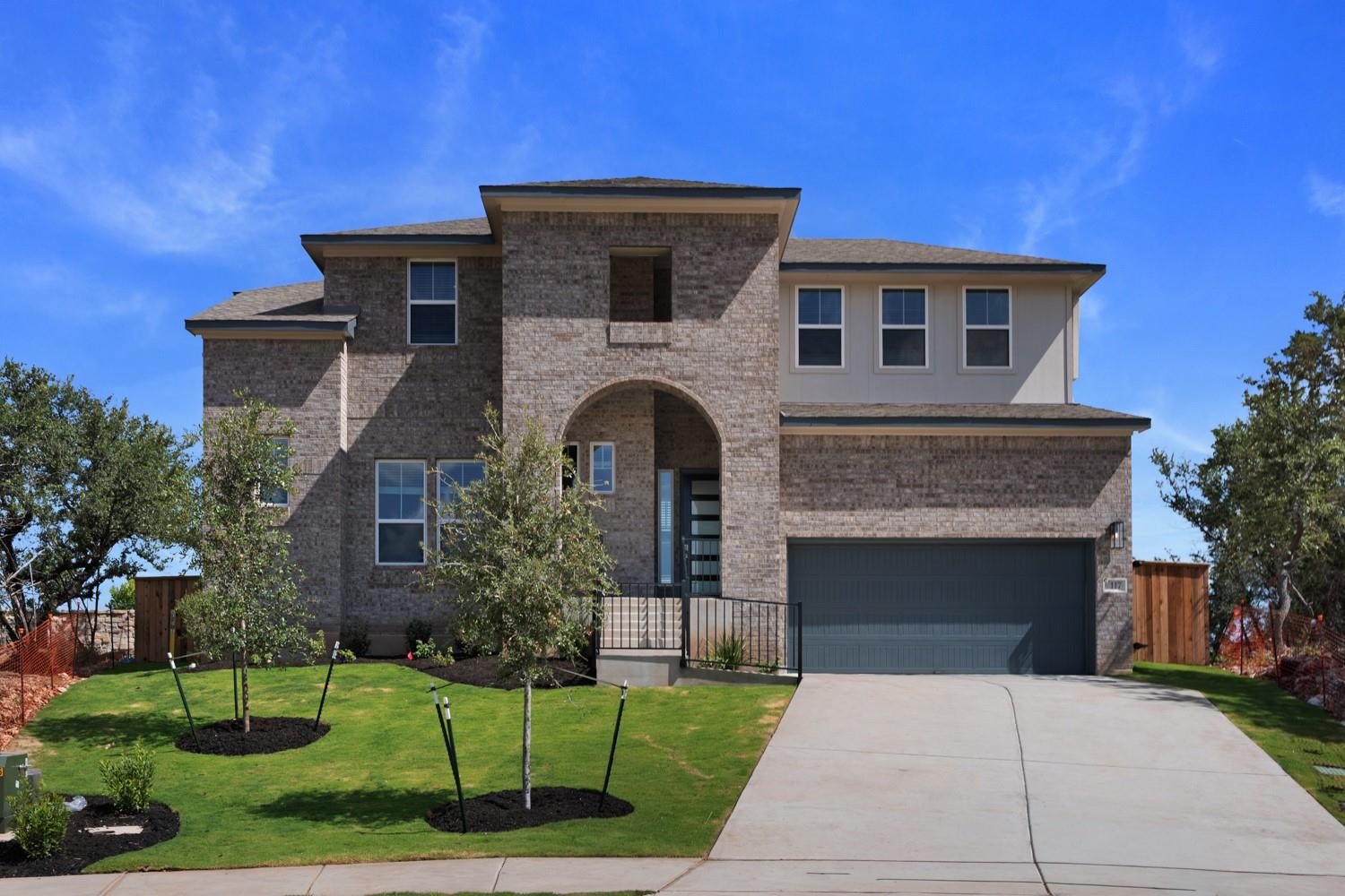 An arched entryway and multi-textured brick facad