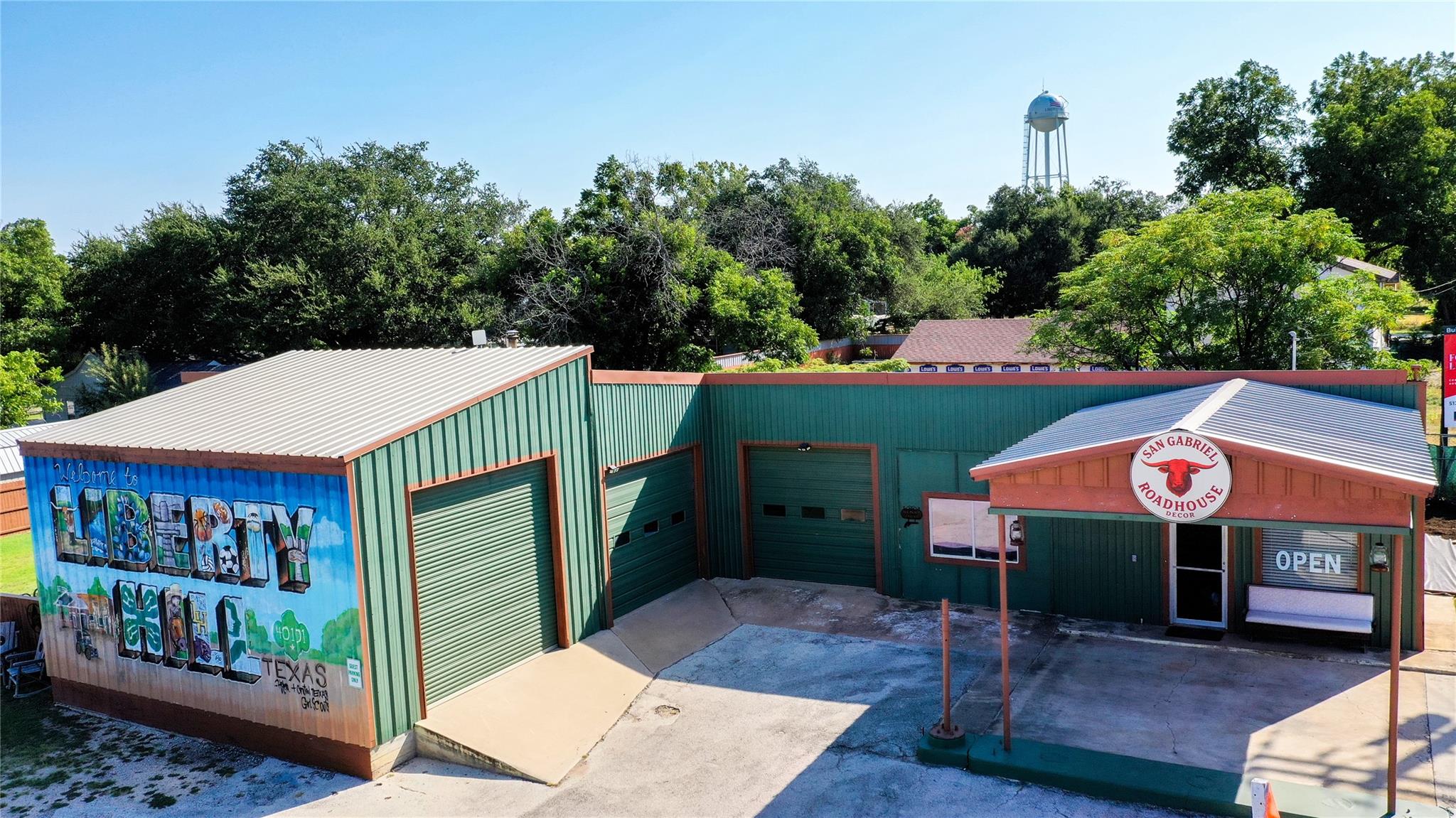 A metal commercial structure features multiple ga