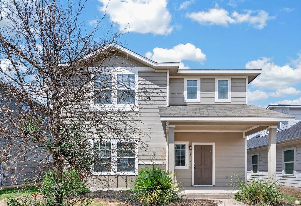 Crisp siding and a welcoming covered porch define