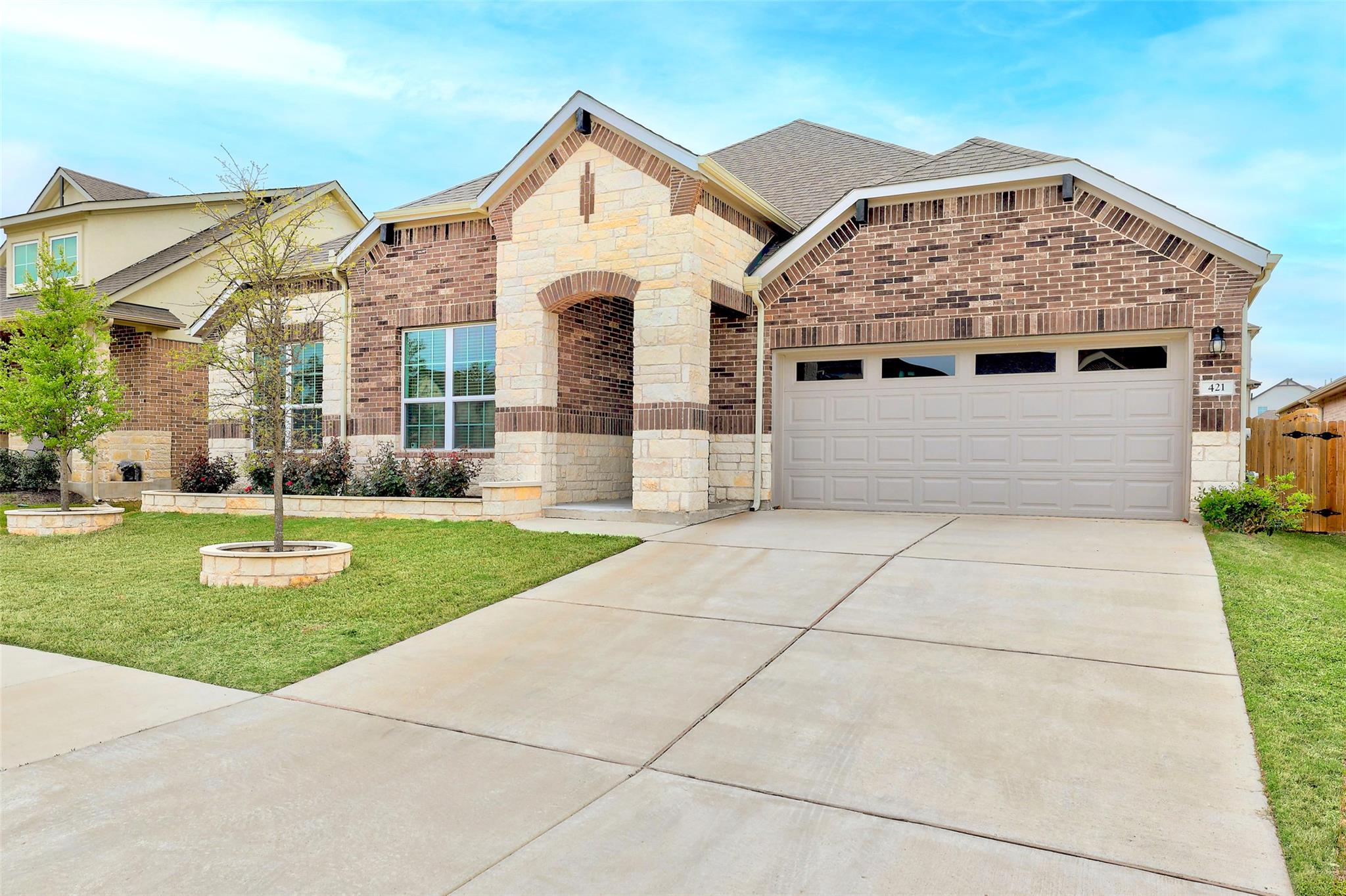 French country style house with stone siding, a s