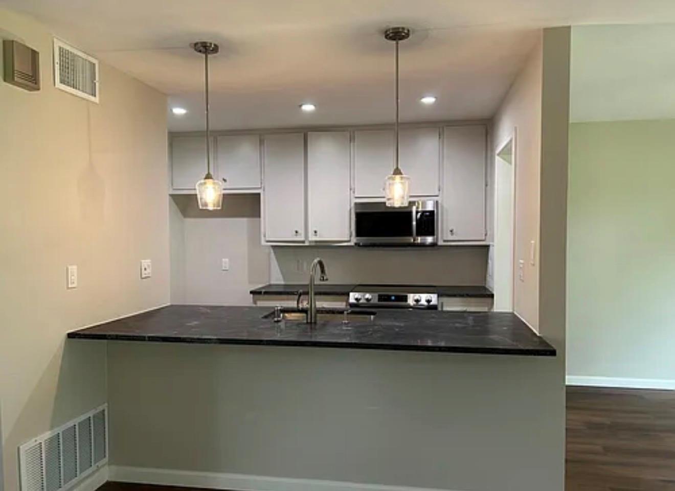 Dark stone countertops and classic cabinetry anch
