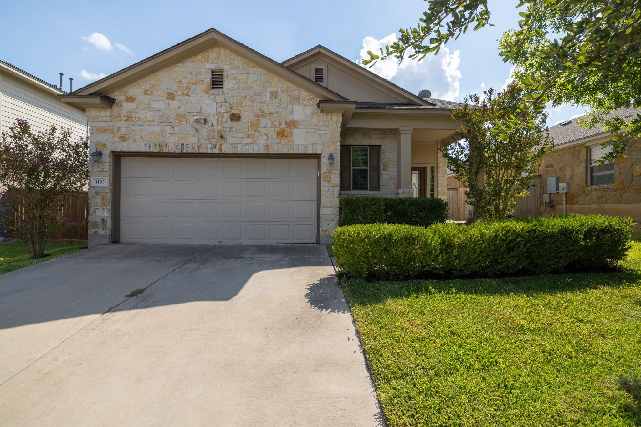 Natural stone masonry and a concrete driveway def