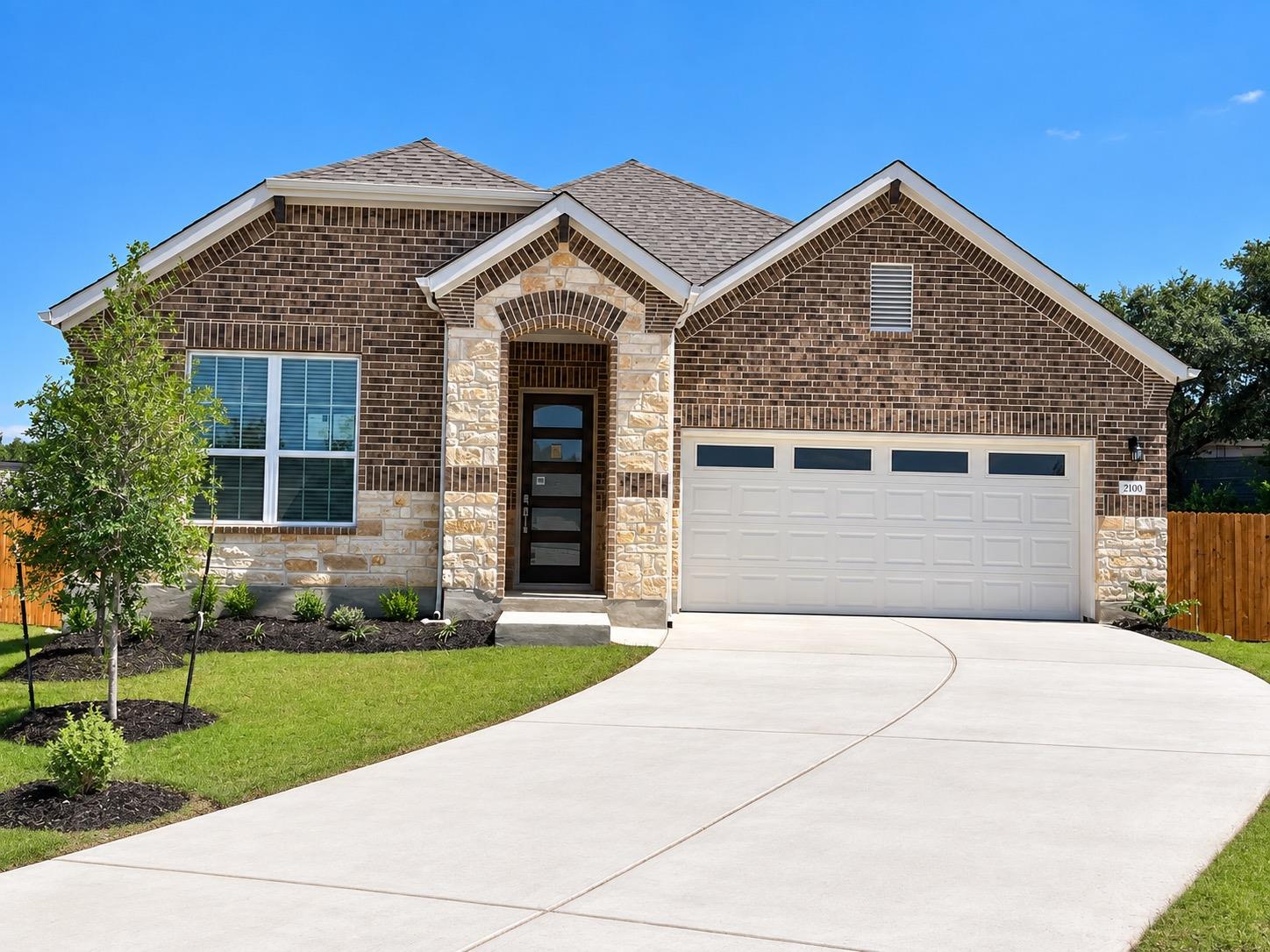 A sweeping concrete driveway leads to this classi
