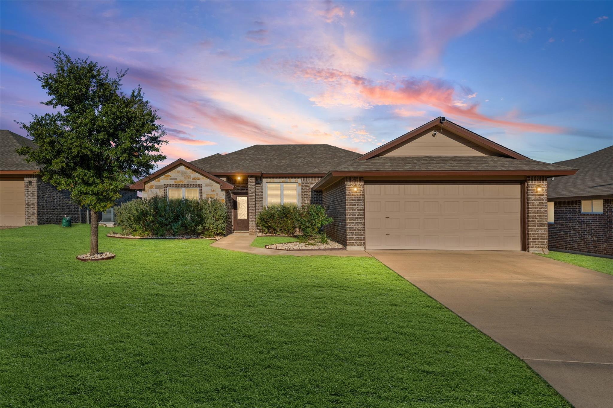 A classic brick exterior and a concrete driveway 